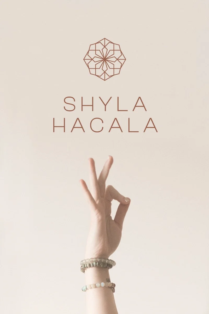 A hand with bracelets making the yoga gesture 'OK' in front of a plain beige background, with the text 'Shyla Hacala' and a geometric logo above.