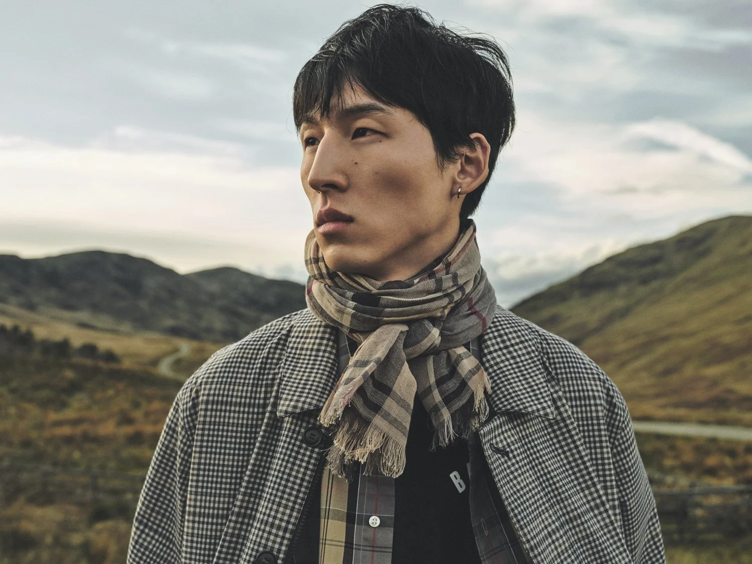 Woo Sang wears a Barbour Tartan scarf, shot by Dan Jackson for the Barbour Tartan Kinship campaign, shot in Scotland.