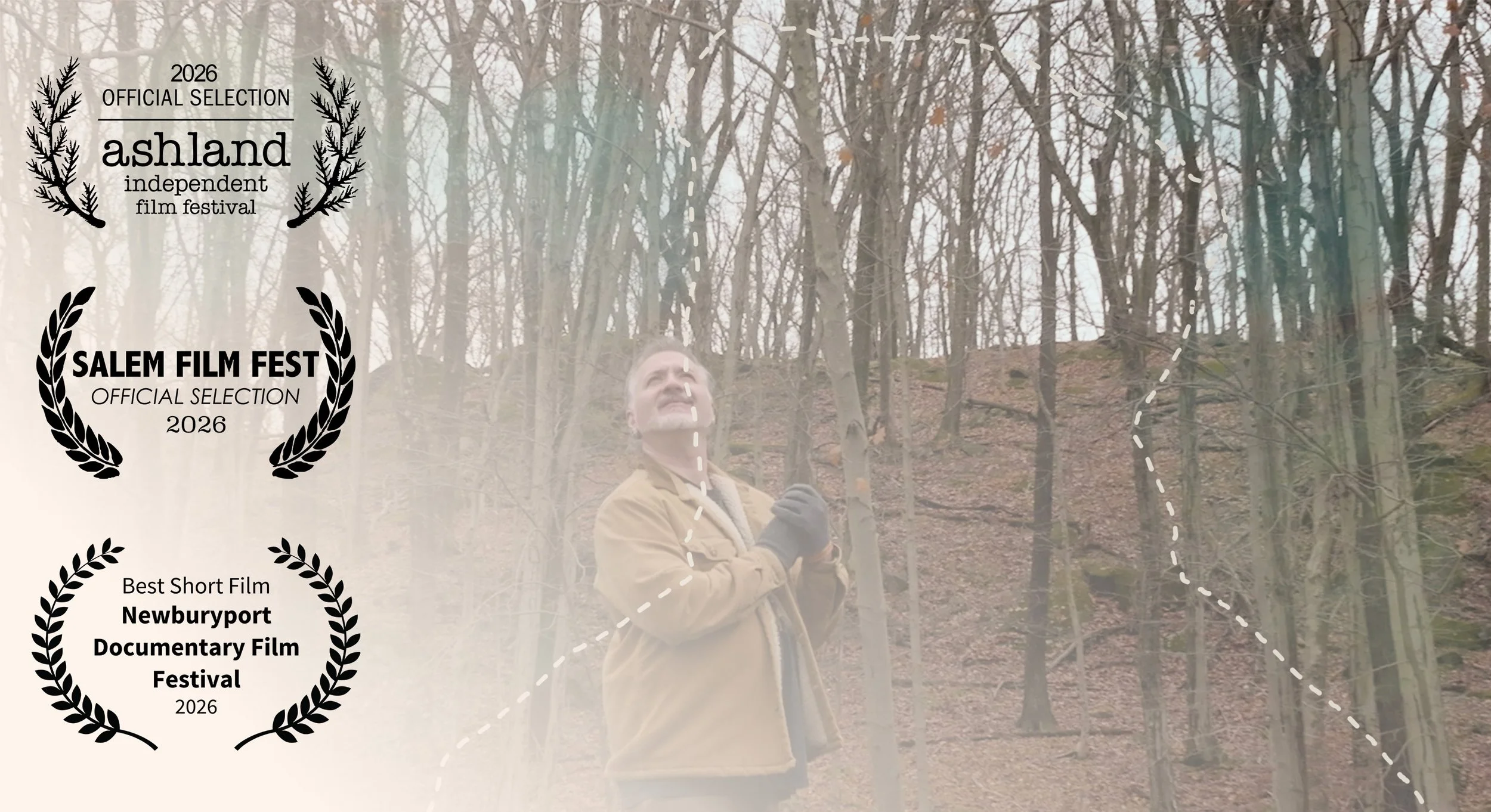 Man standing in a wooded area during fall, wearing a tan jacket and gray gloves, looking upward, with a small hill and trees with orange and brown leaves in the background, overlaid with film festival awards.