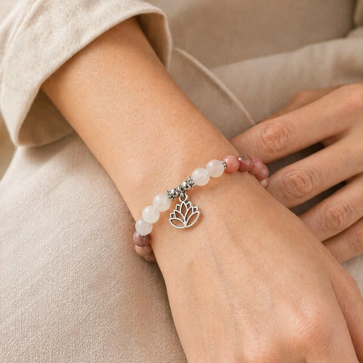 nelGlow Compassion gemstone bracelet featuring Rose Quartz beads and a delicate lotus charm.