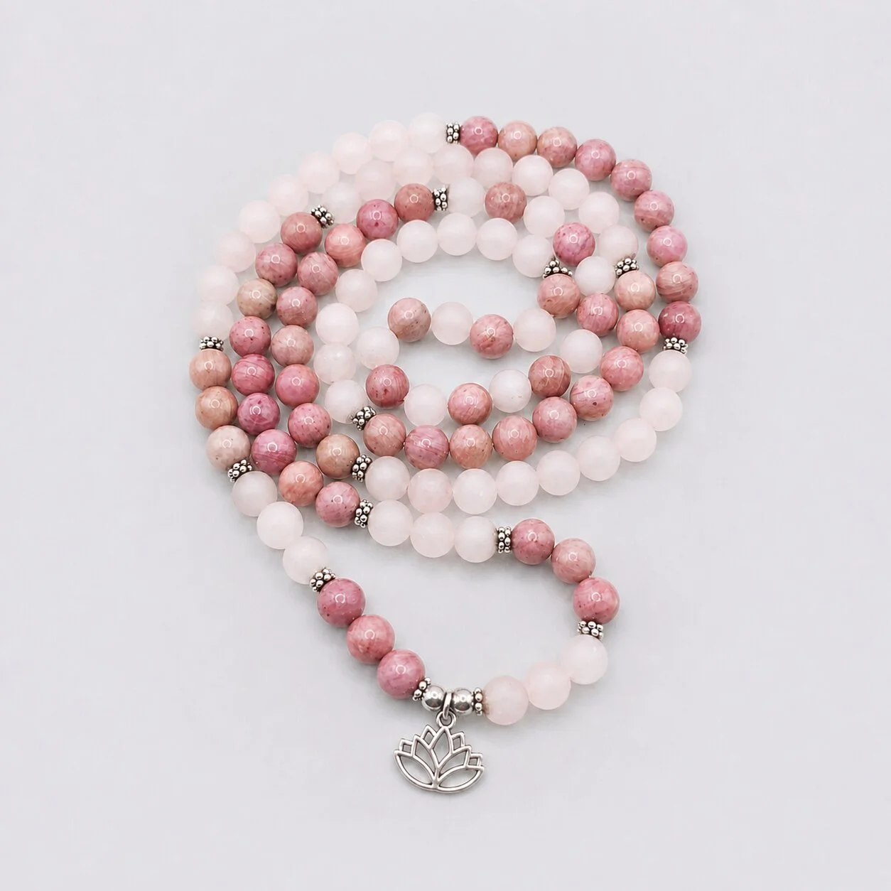 Close-up of the Compassion Mala with soft pink Rose Quartz and contrasting Rhodonite beads.
