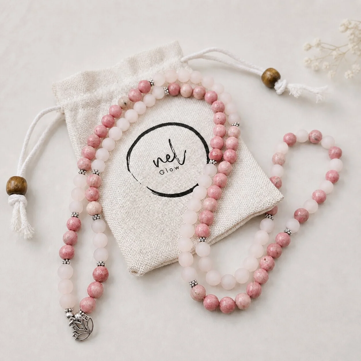 nelGlow Compassion Rose Quartz Mala, wearable as a long necklace or wrapped around the wrist.