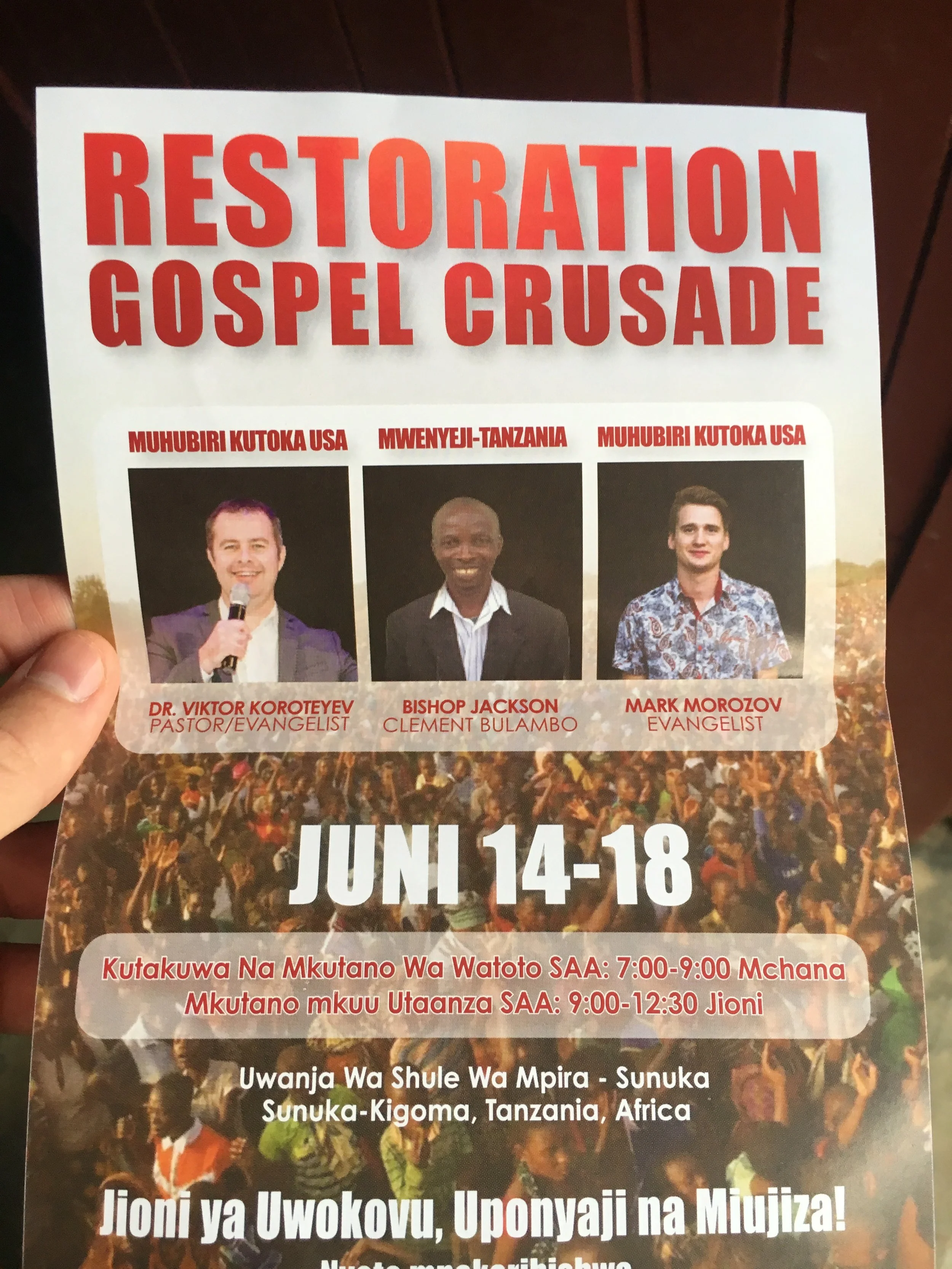A flyer promoting the Gospel Crusade Restoration event scheduled for June 14-18, featuring photos of speakers Dr. Viktor Koroteyev, Bishop Jackson, and Mark Morozov, and including event details in Swahili about the venue and timings.