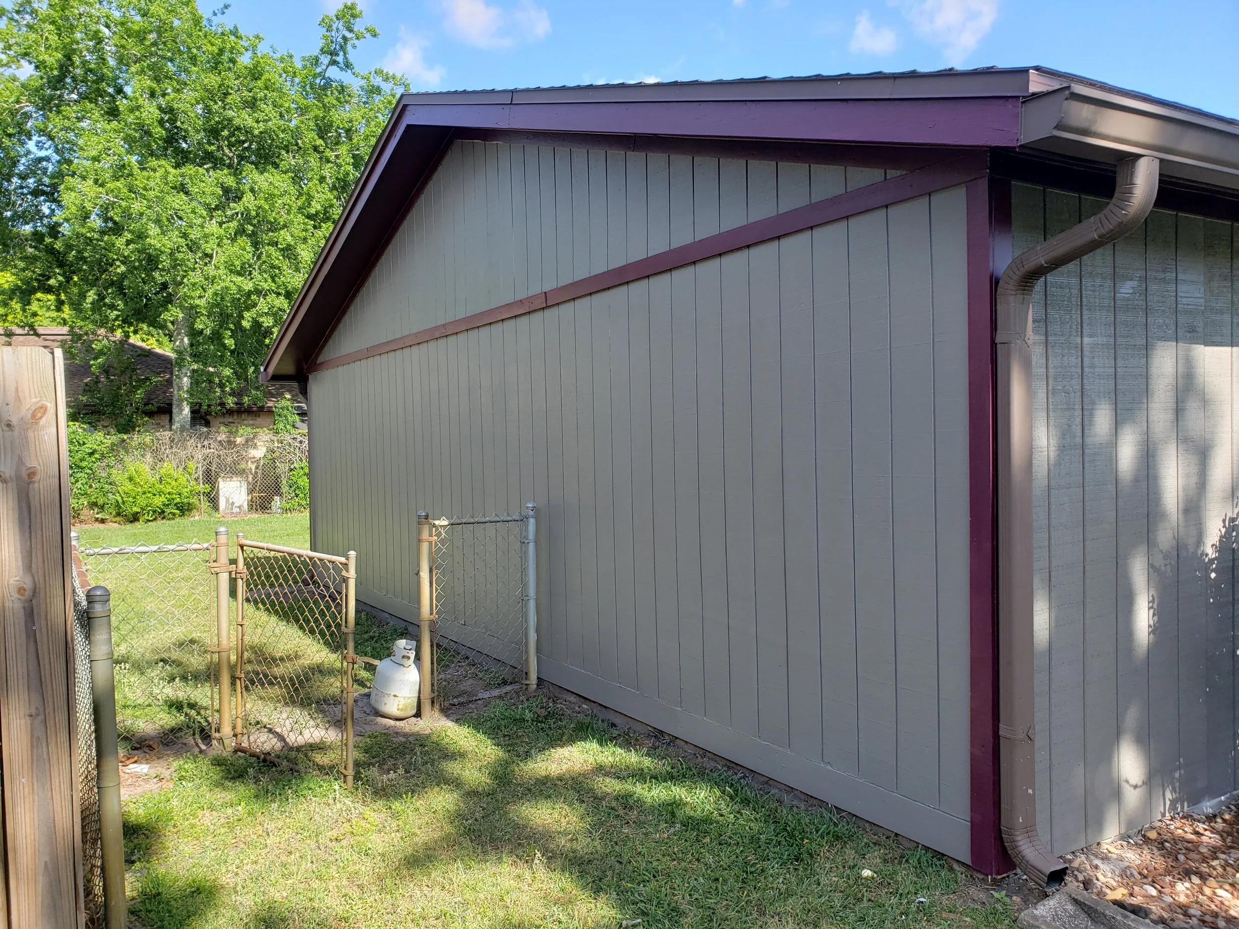 Picture of the right side of the house also the 2nd area of newly installed T 1-11 Siding