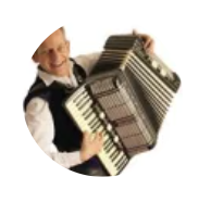 Person smiling and holding an accordion.