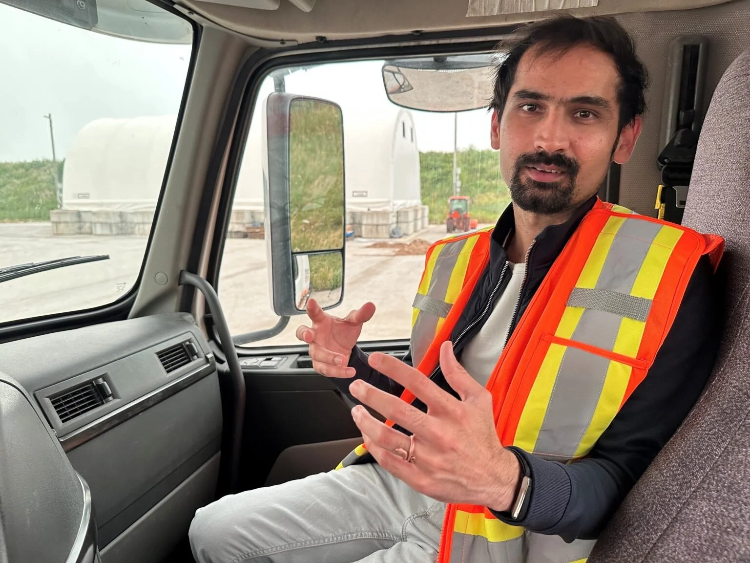 Raghavender Sahdev speaking from the cab of a truck