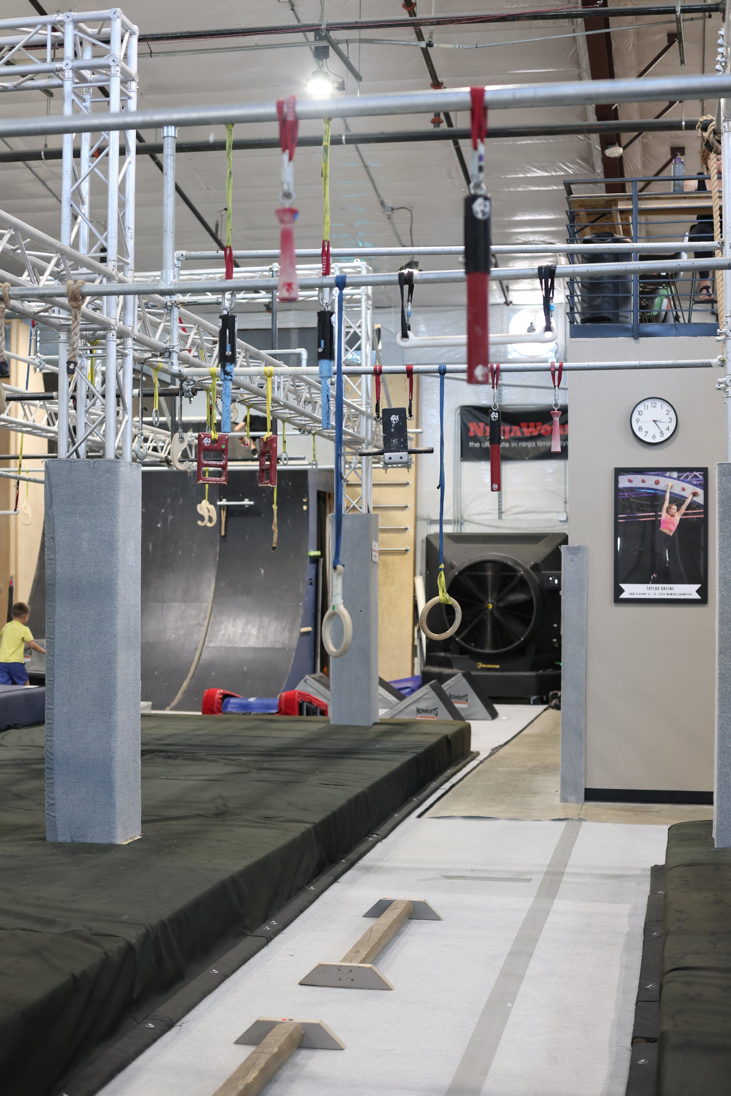 	
ARK Ninja Longmont Ninja Warrior gym obstacle course with hanging rings, climbing obstacles, balance course, and padded landing mats