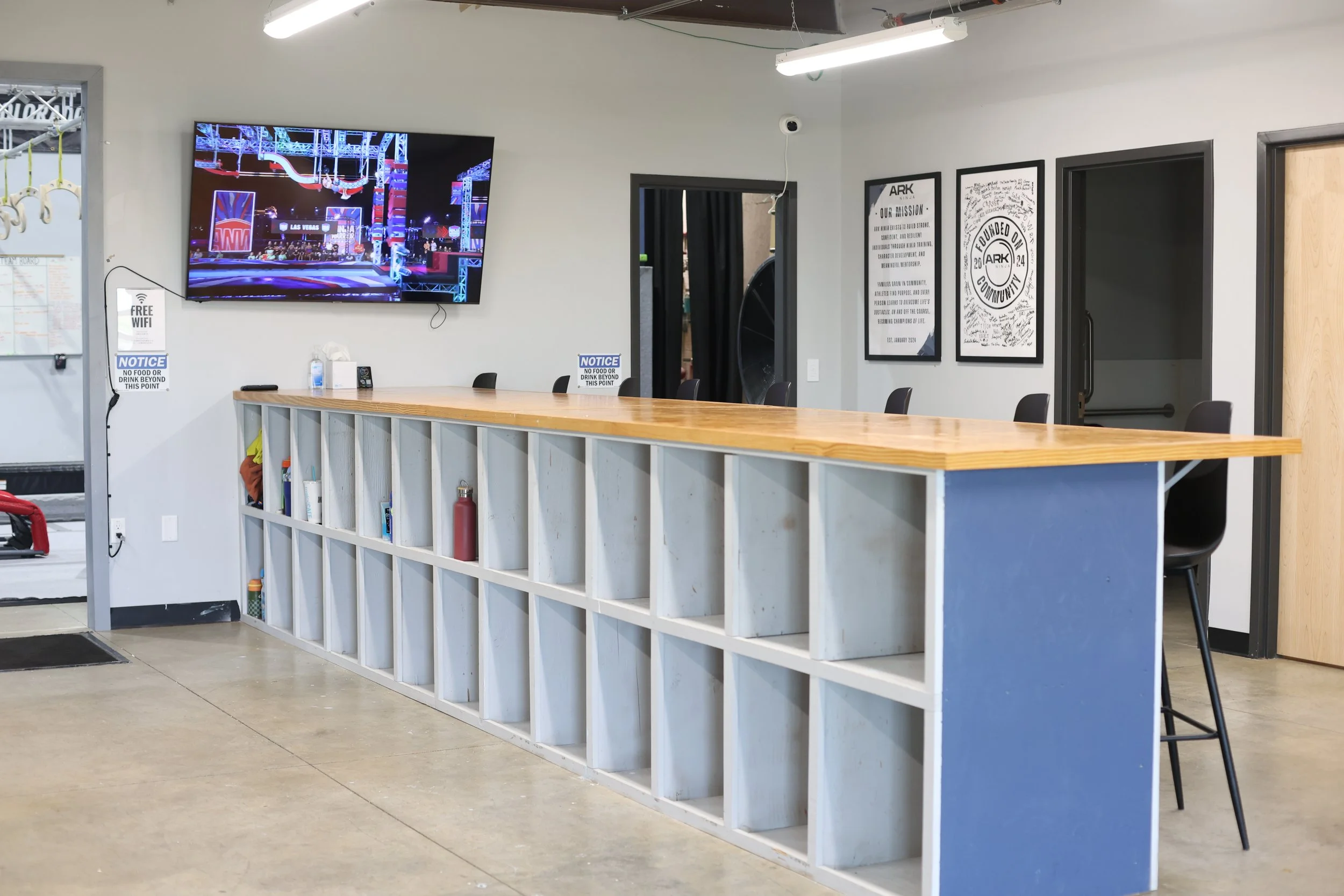 ARK Ninja Longmont gym front desk and lobby with seating and Ninja Warrior training area