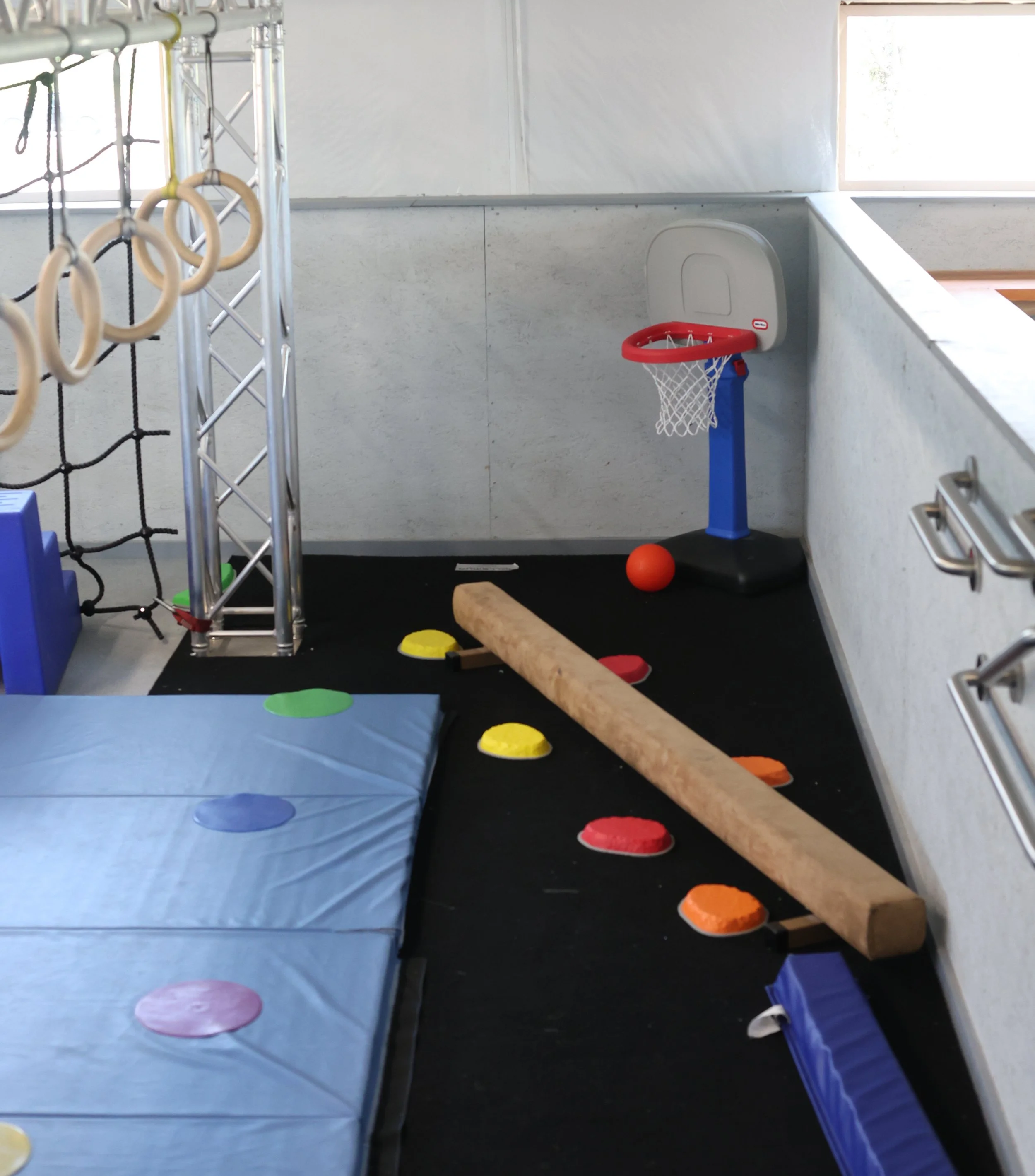Mini Ninjas area for 2-4 year olds with balance beam, stepping stones, and beam.