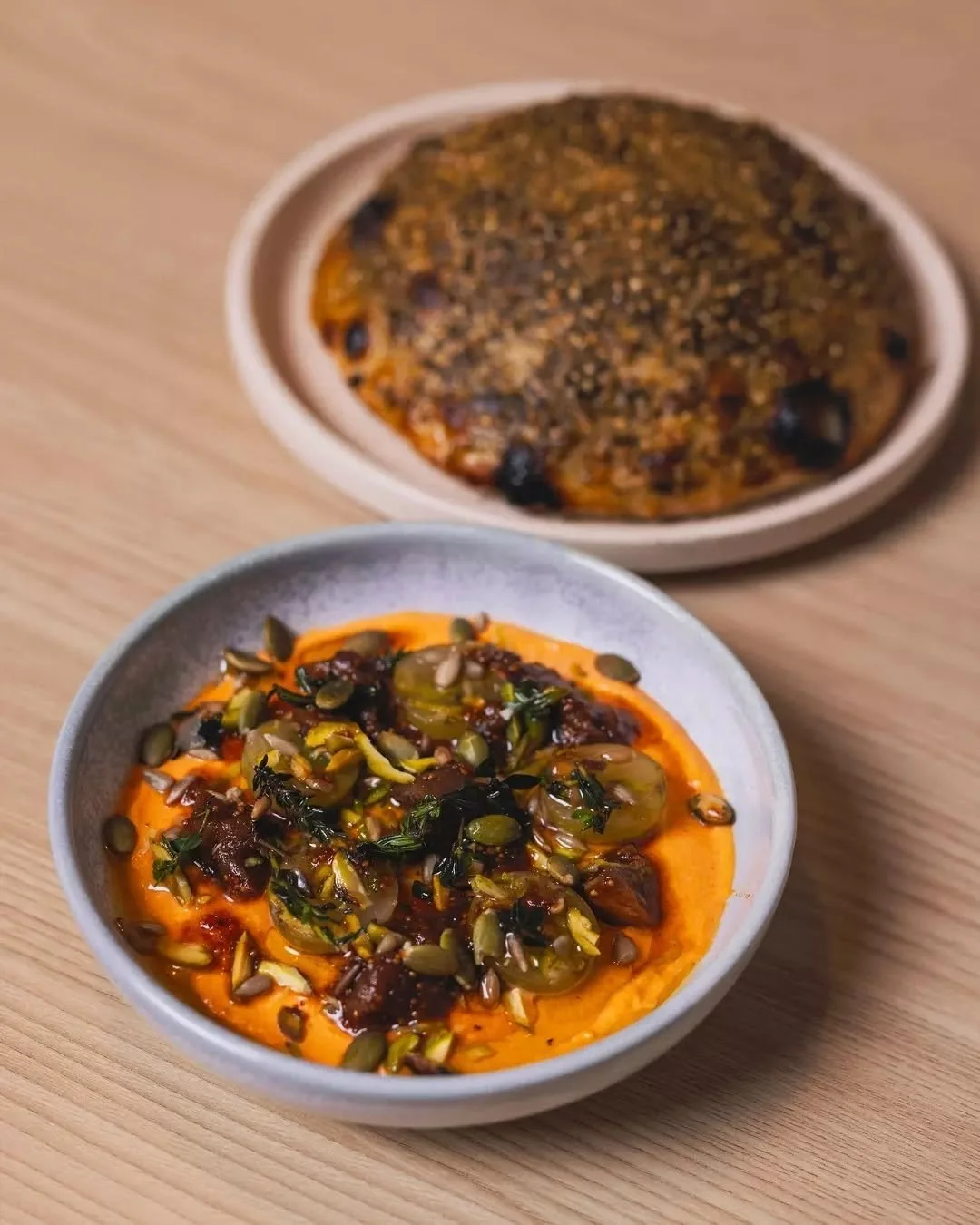 Fresh baked bazlama bread with za&rsquo;atar.
Whipped feta topped with pickled grapes, candied figs and pistachio.

The perfect pair to start your meal 🤤

📸 @lukelattyphoto @busseltoncentral
