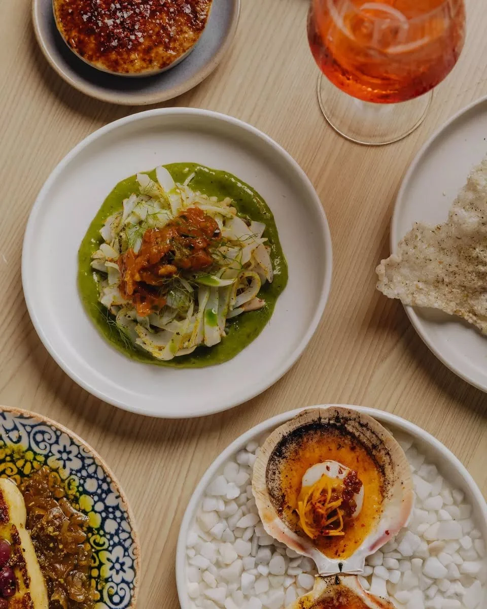 A Thursday evening kind of table 🍊

Scallops in the shell. Cuttlefish on a bed of green parsley tahini. An Aperol spritz. A few hours of absolutely nowhere else to be.

Dinner from Tuesday ~ bookings via the link in bio.