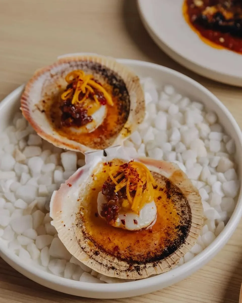 One is never enough.
Abrolhos Island scallop ~ caramelised pumpkin butter, pickled pumpkin, sunflower-shatta. Served in the shell, still warm from the grill.

On the Autumn menu now.