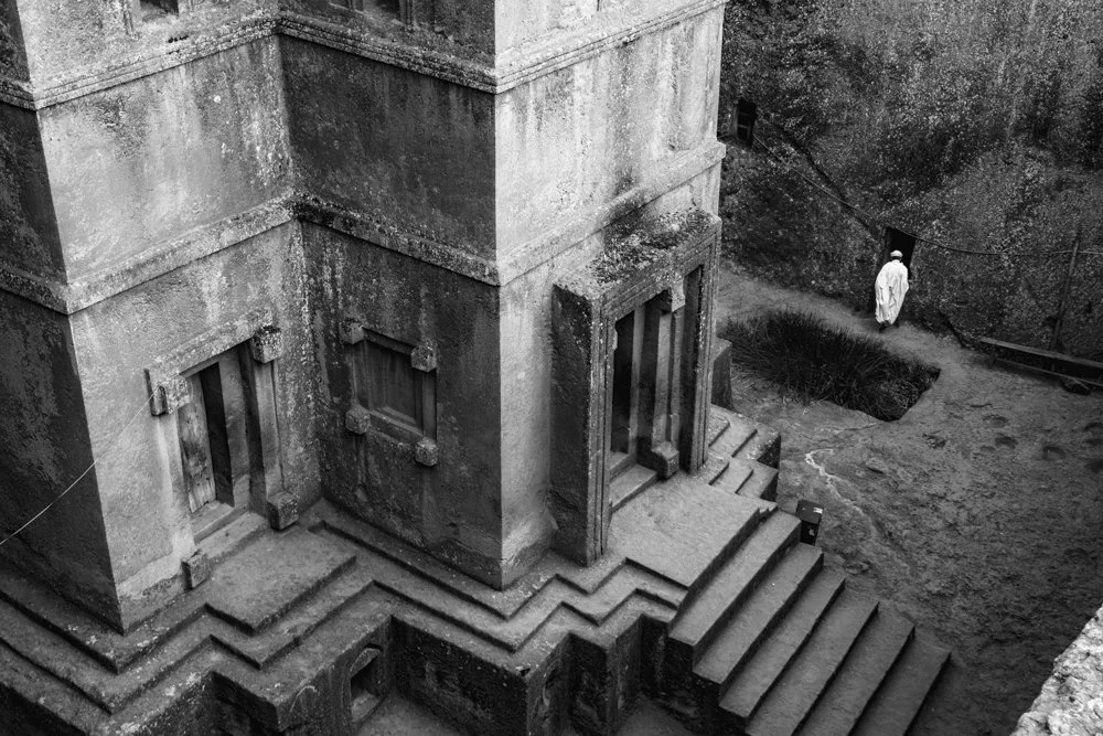 A priest exits Bete Giyorgis (The Church of St. George), Lalibela in Ethiopia