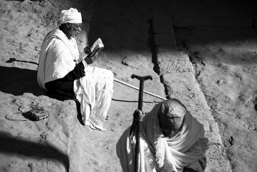 A pilgrim and a nun within the rock-hewn churches at Lalibela, Ethiopia