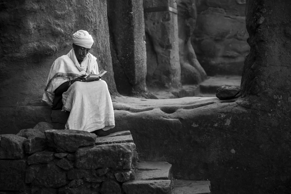 An Ethiopian priest studies within one of the churches