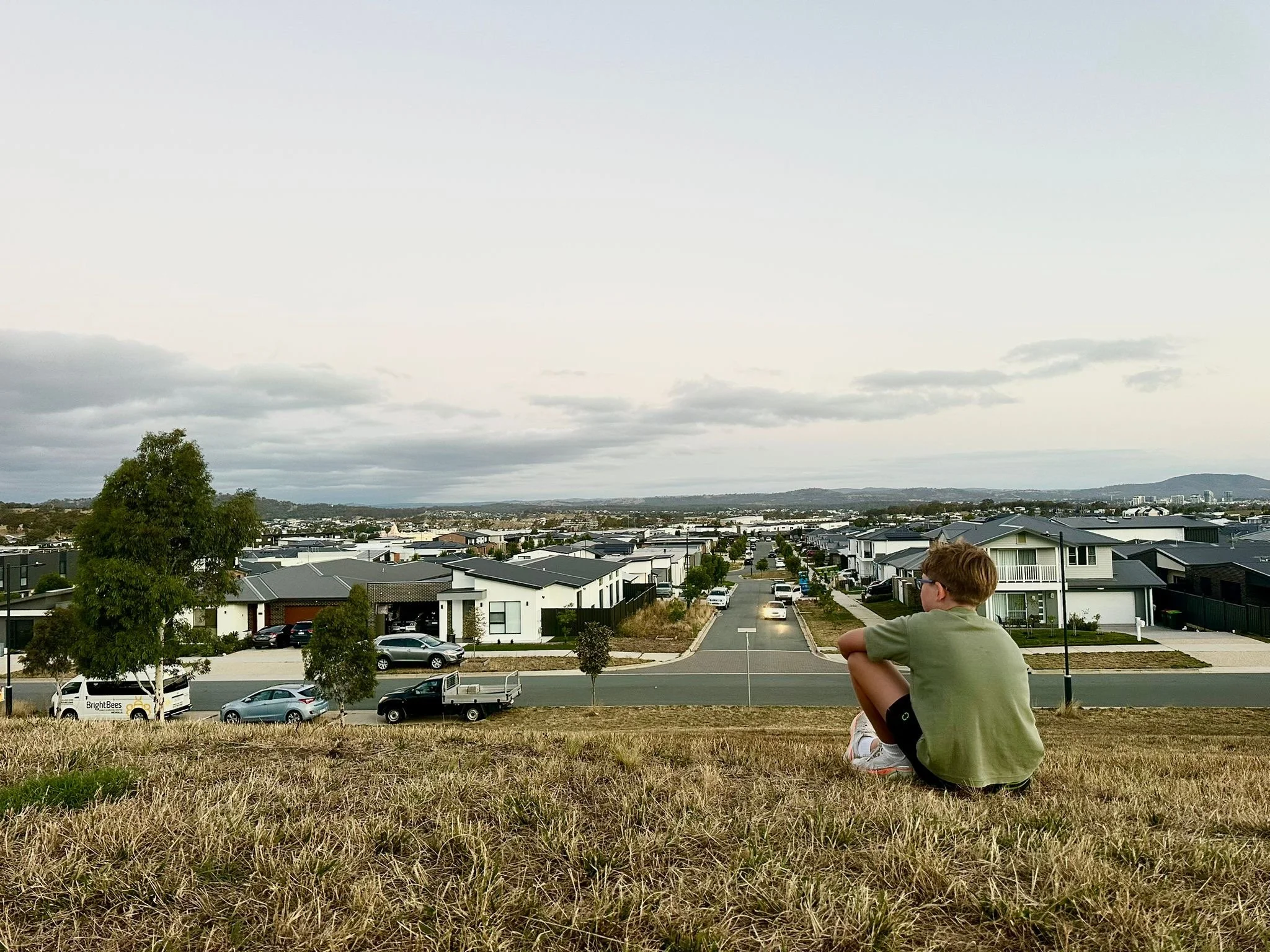 Person overlooking suburban housing growth on the edge of an Australian city.