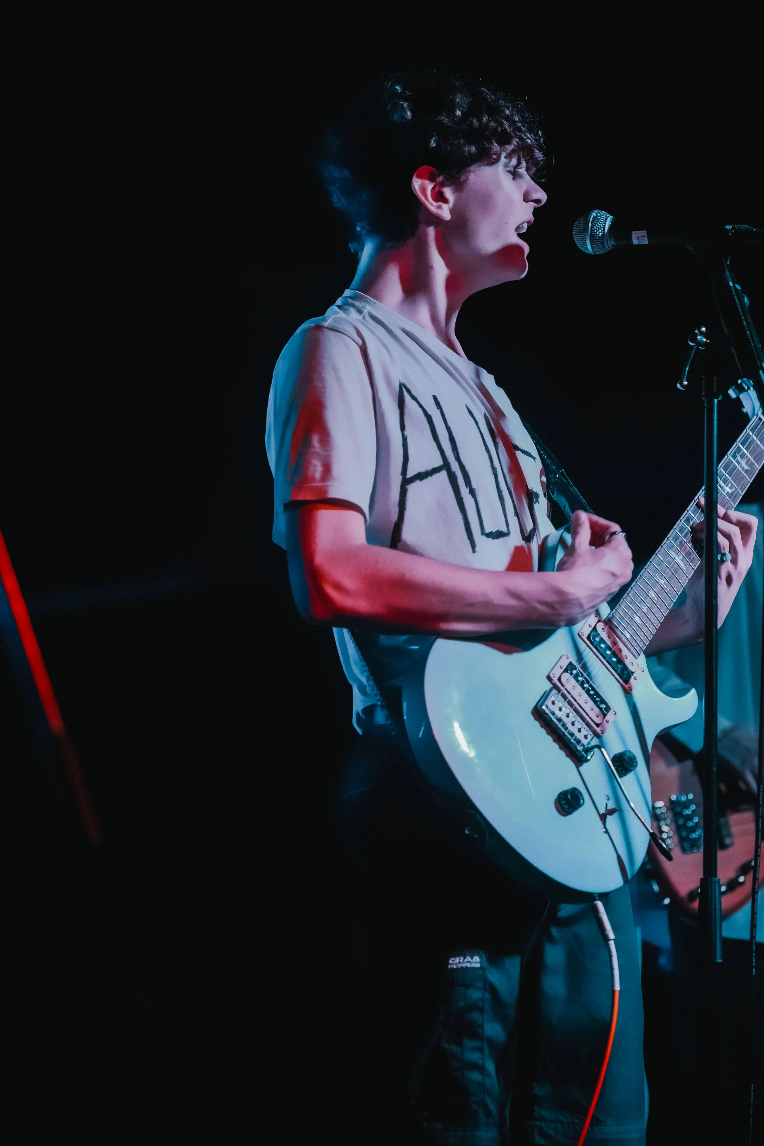 Musician playing electric guitar on stage