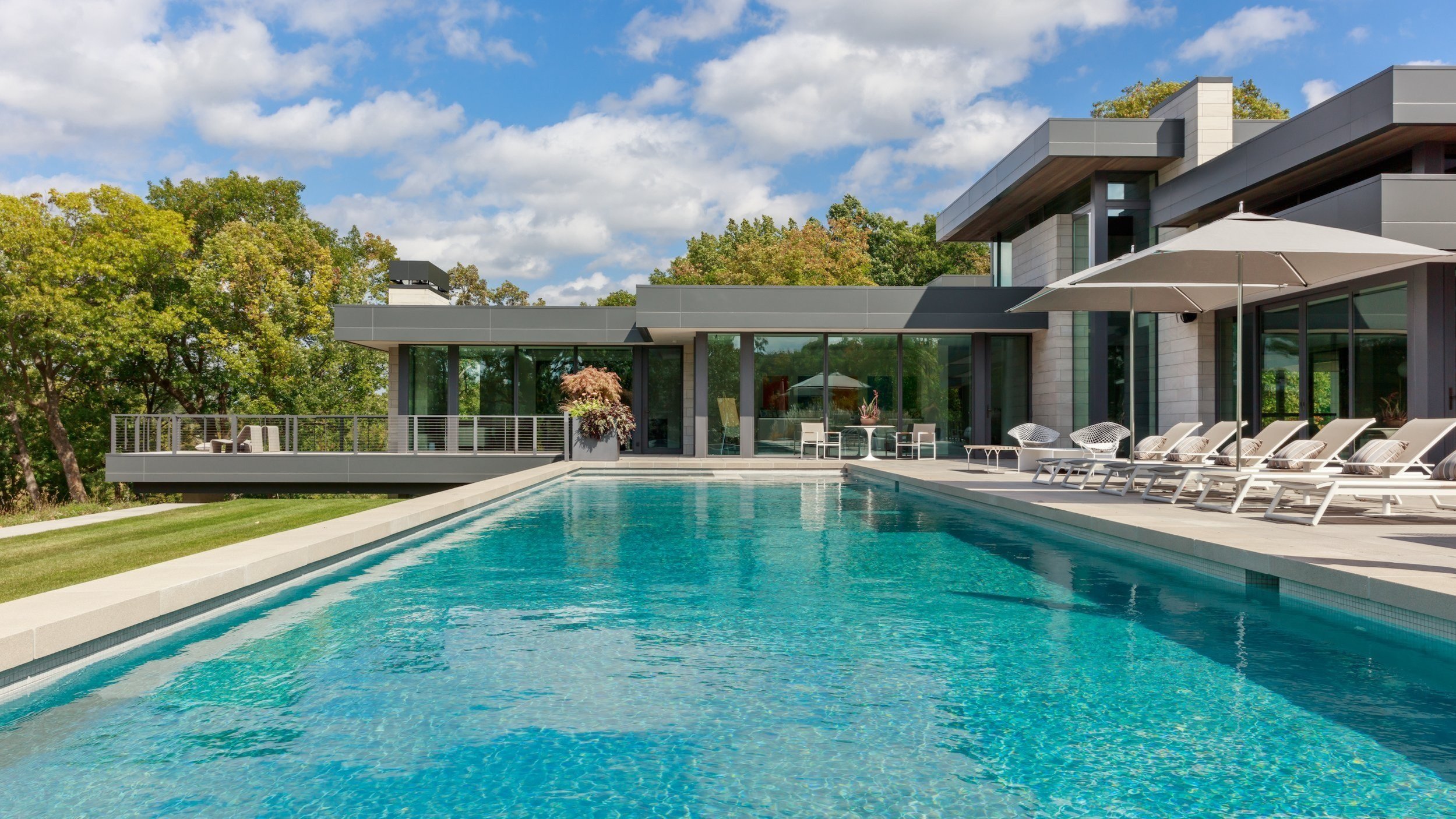 A warm modern home with a swimming pool in the backyard and ample patio space
