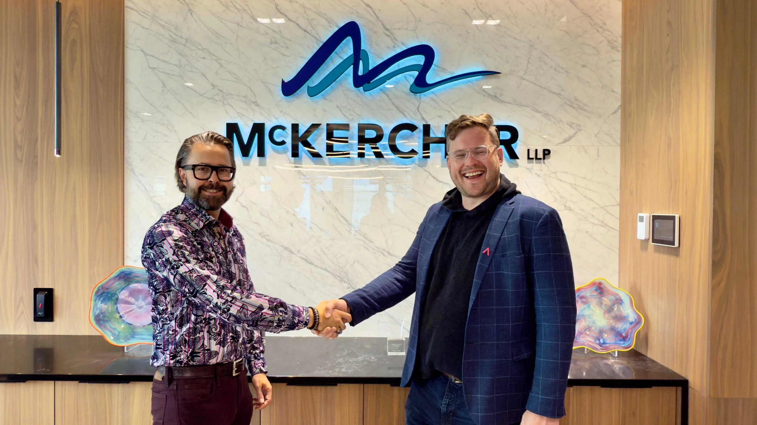 McKercher Partner and Lawyer Joe Gill shaking hands with Startup TNT's Jesse Wiebe on the new sponsorship agreement.
