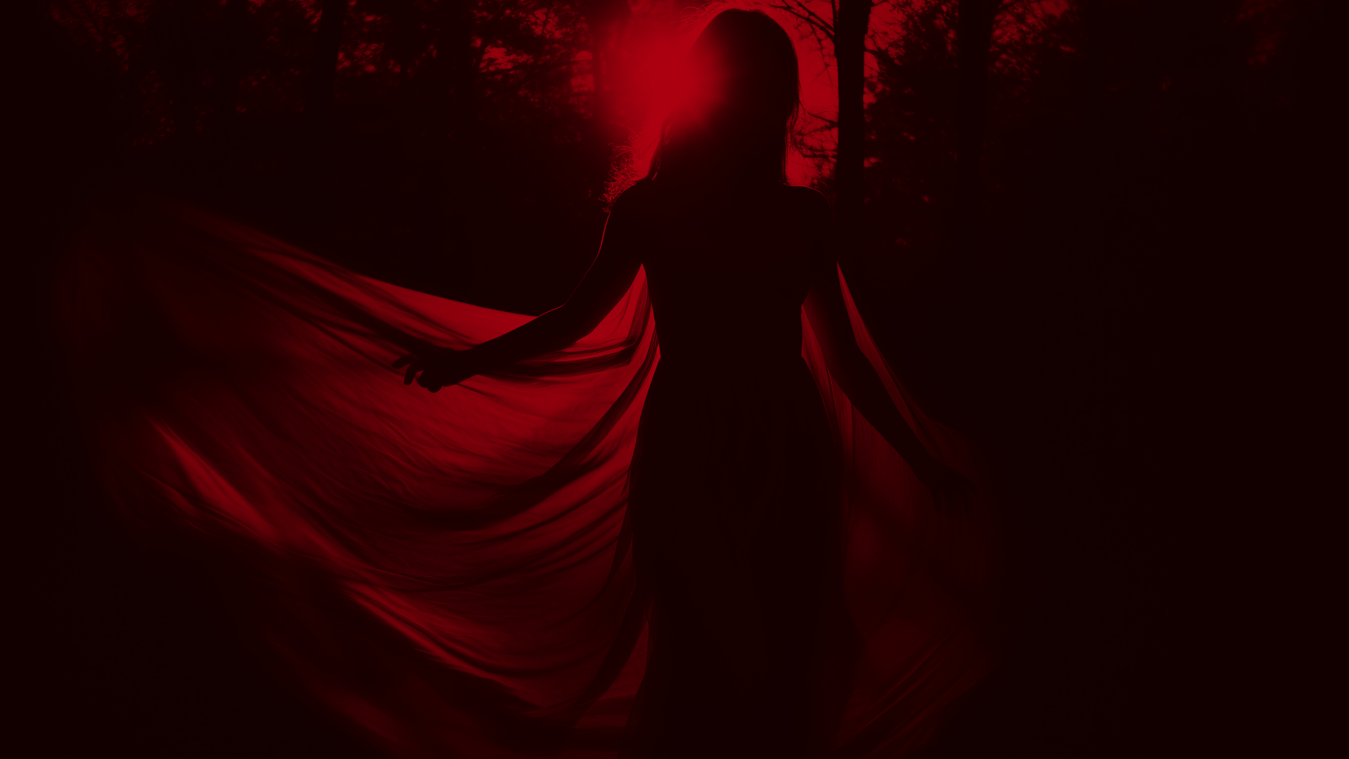Dark silhouette of a woman in a flowing red dress standing in a forest