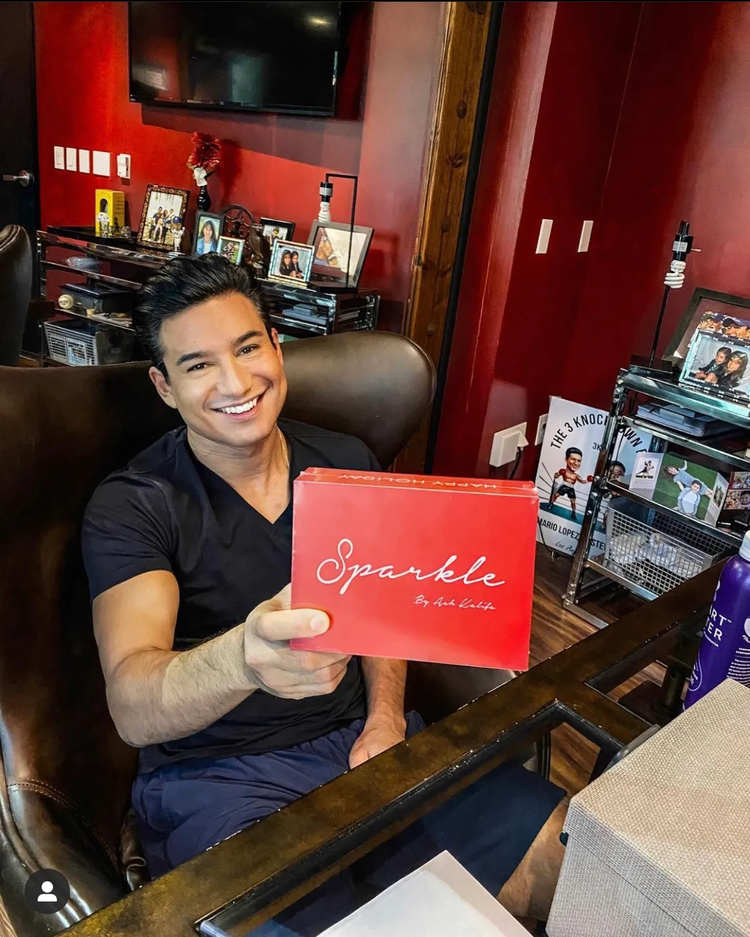 A man holding a red Sparkle Me White box in a studio