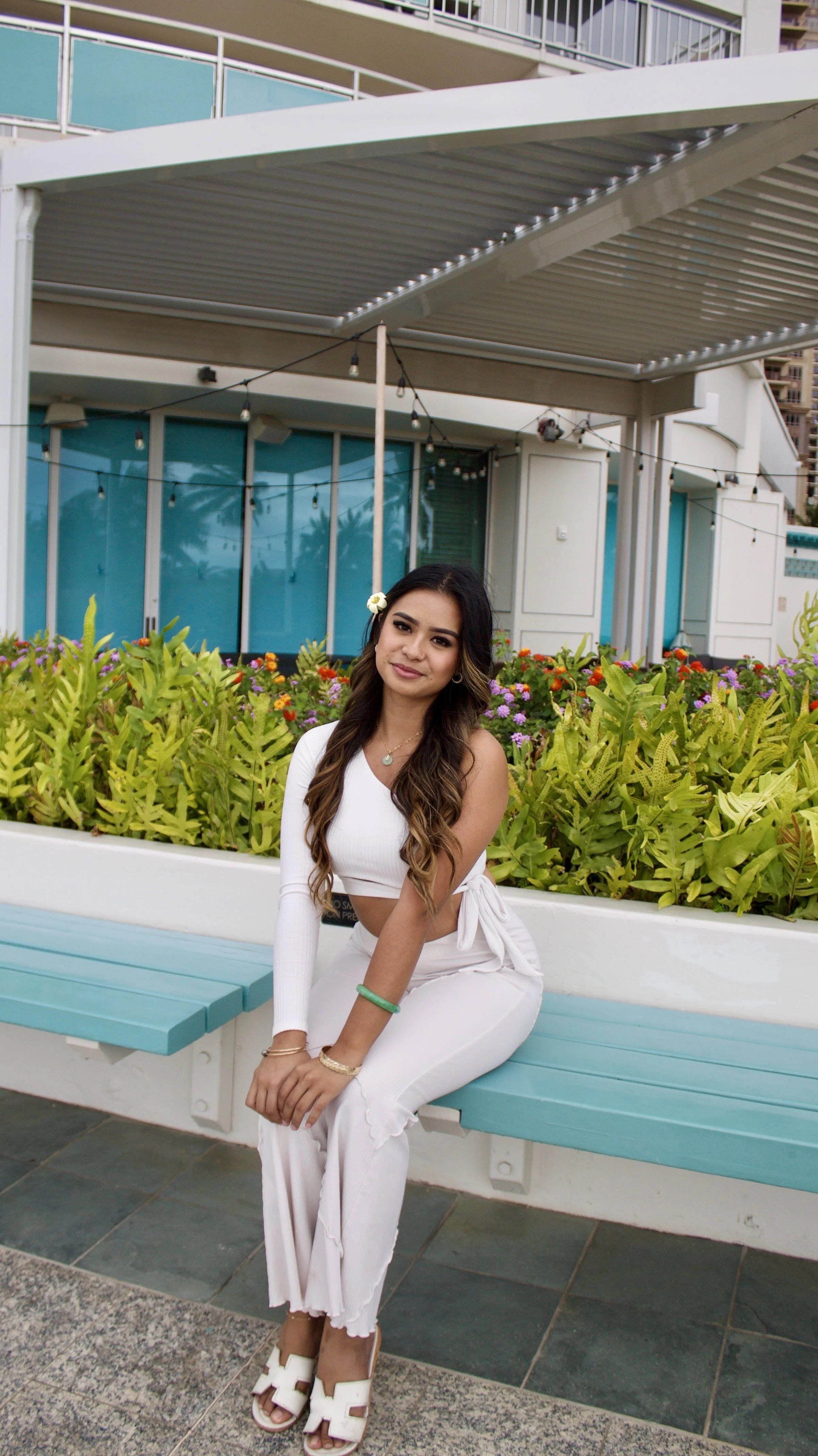 A beautiful influencer posing on a bench for a product photoshoot, showcasing the power of influencer marketing to connect brands with engaged audiences.