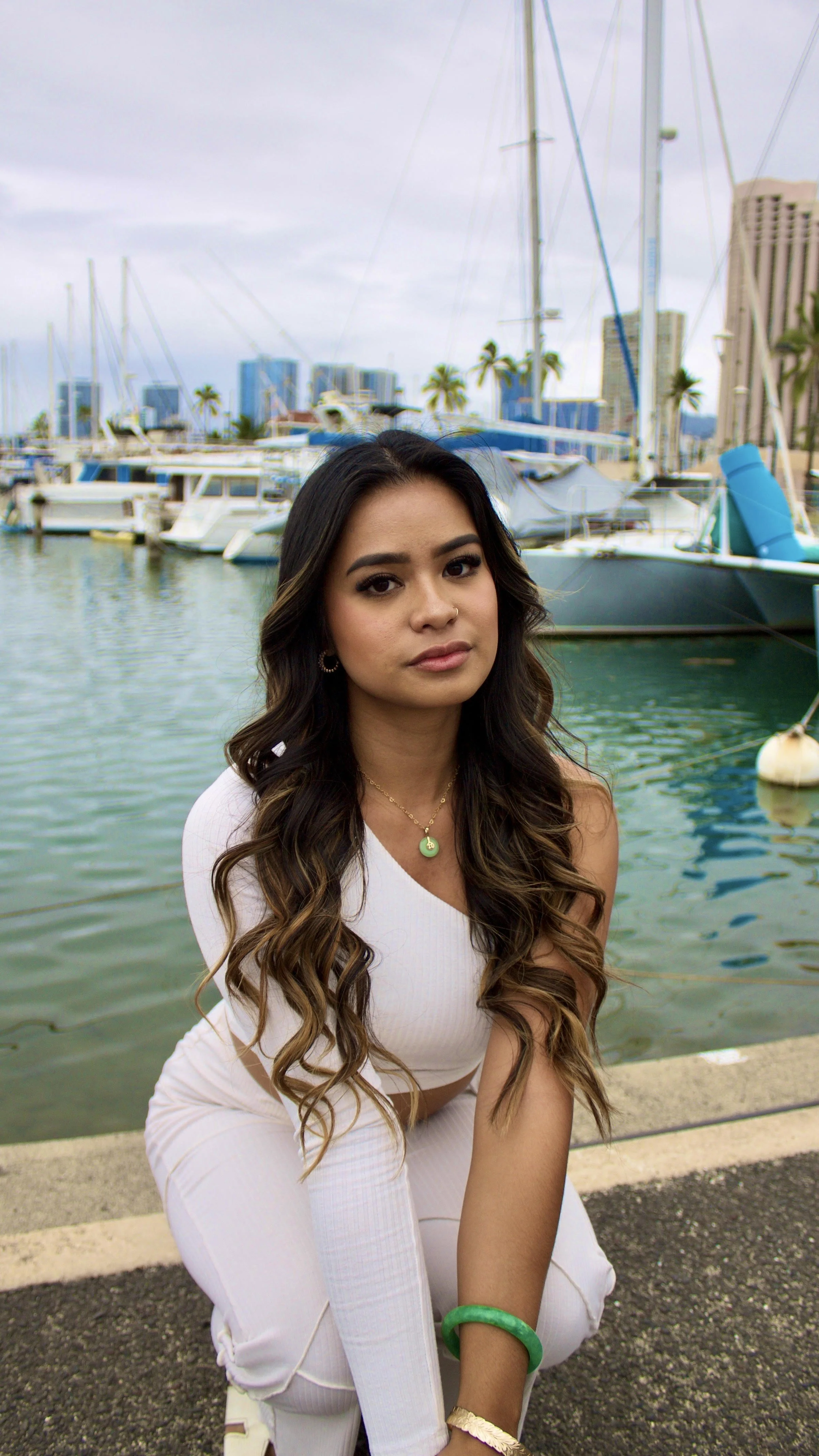 A beautiful influencer at the marina for a product photoshoot, showcasing the power of influencer marketing to connect brands with engaged audiences.