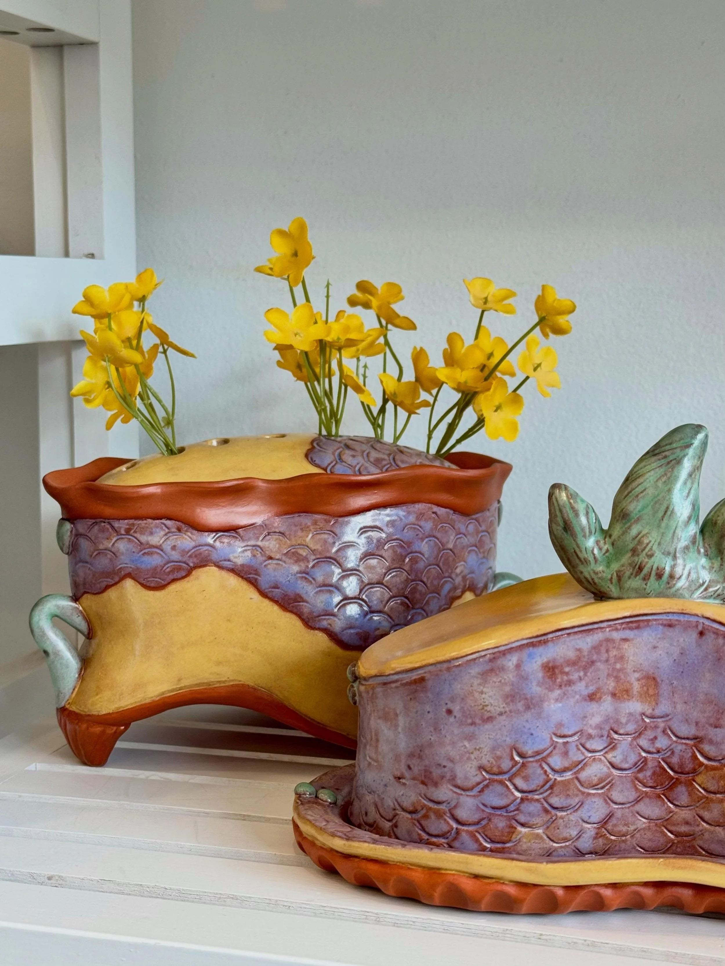 Come celebrate Mom with Julie Cunningham&rsquo;s whimsical butter dishes, vases, and more!

Julie is one of our handbuilding instructors specializing in textured earthenware pieces inspired by the shapes and patterns of nature - how fun! 

Stop by an