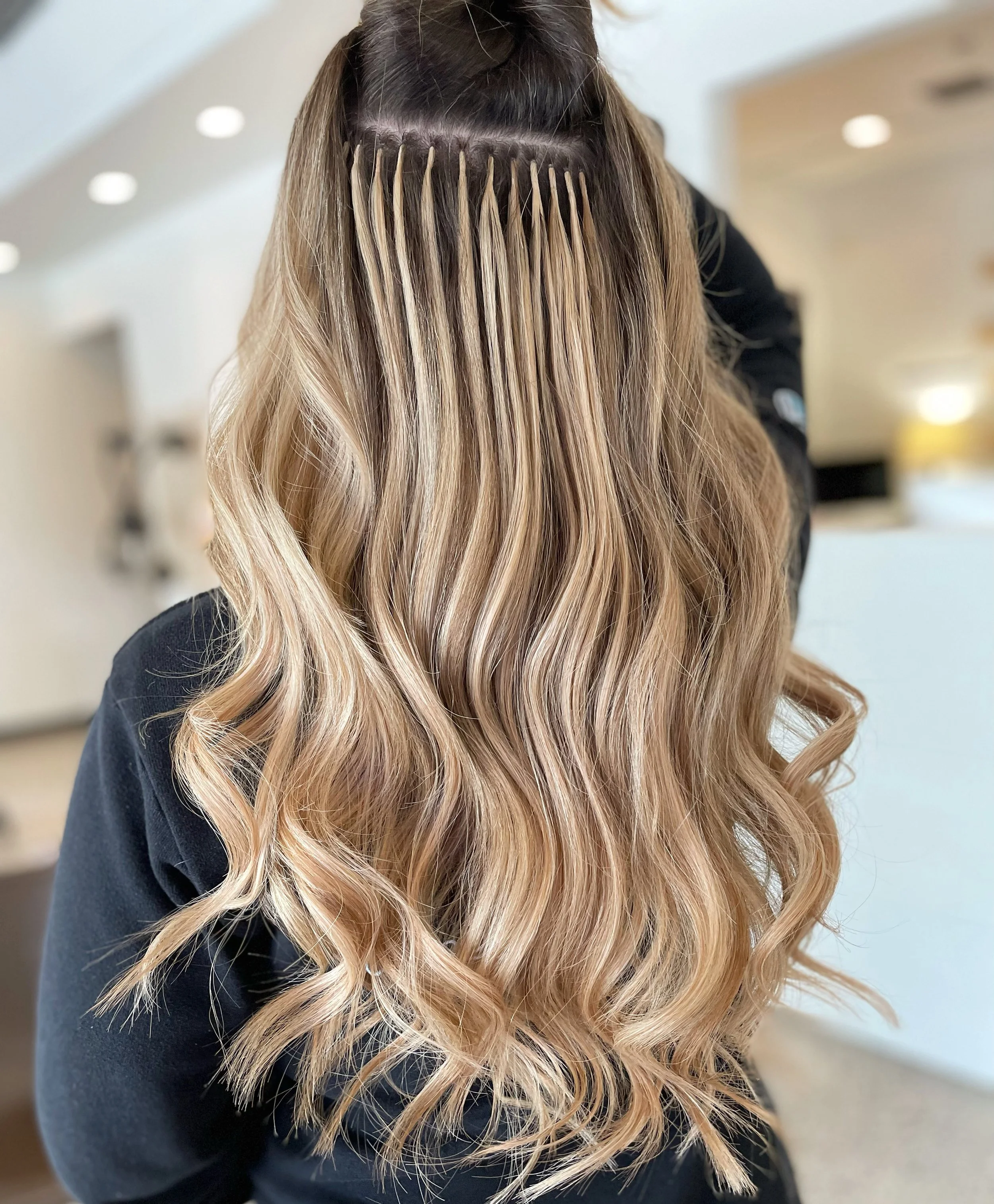 Custom keratin-bonded hair extensions by Blend Salon stylists