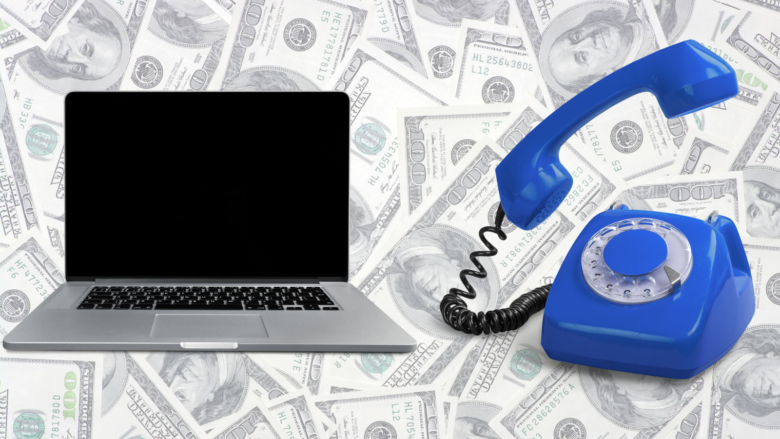 A laptop and rotary phone with a background of 100 dollar bills.
