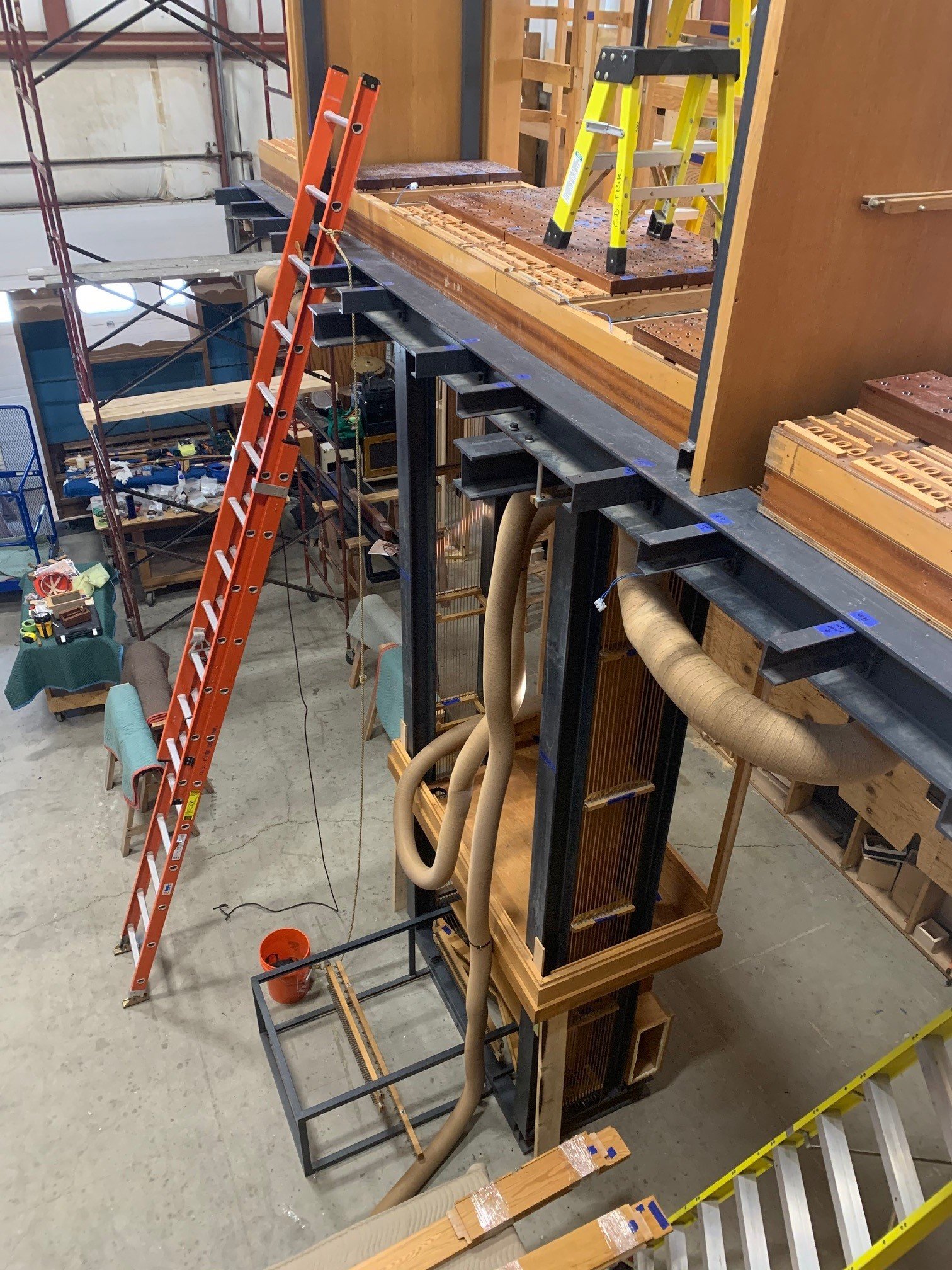   REASSEMBLY AND ASSESSMENT    May 2021   As more of the organ is reconstructed at C.B.Fisk, it becomes clearer how it will eventually be reinstalled at Saint Peter’s. The beginnings of the wooden case are shown here, as well as the wind chests. The 