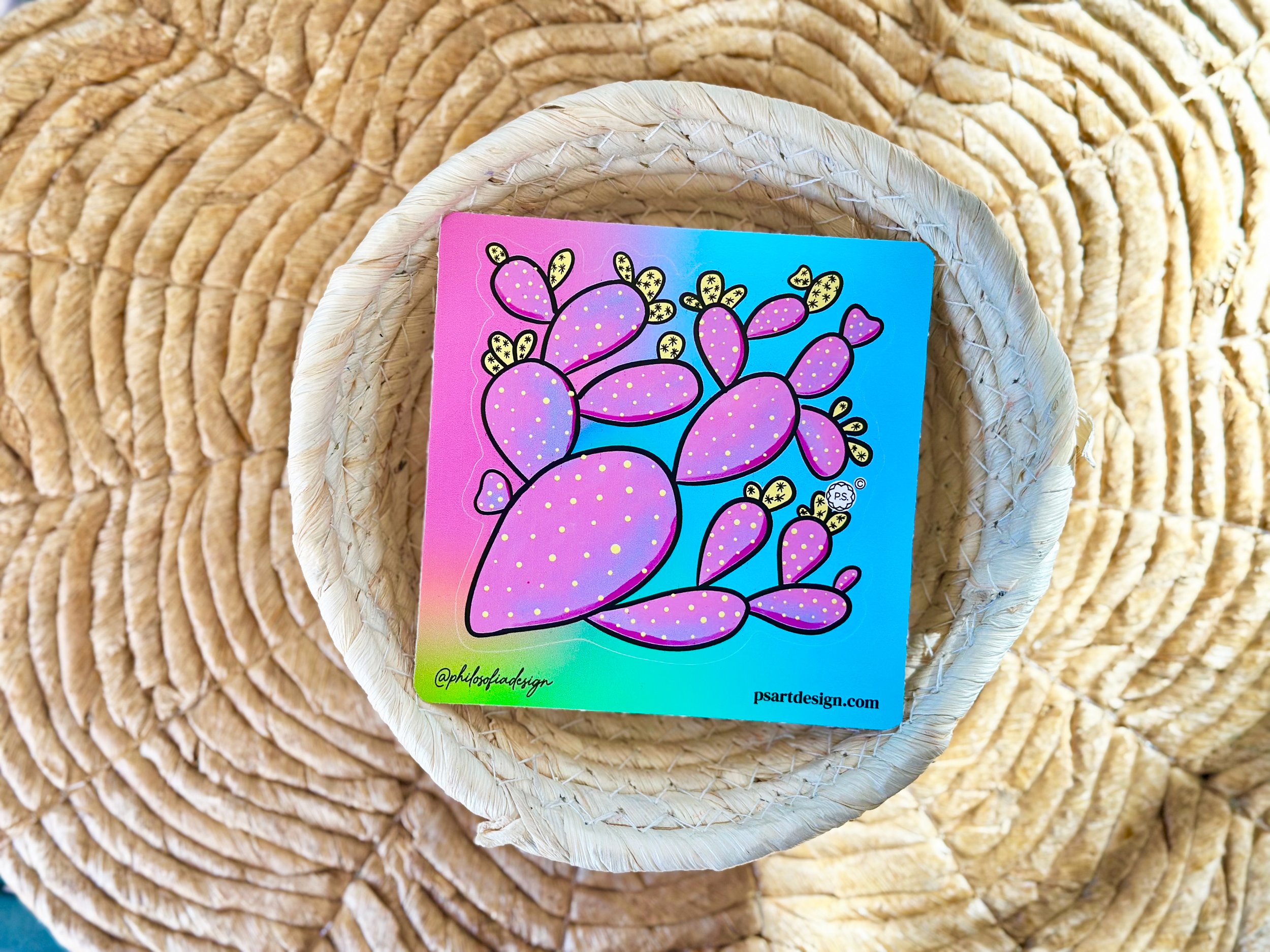 Purple and yellow prickly pear cactus die-cut sticker in a basket.