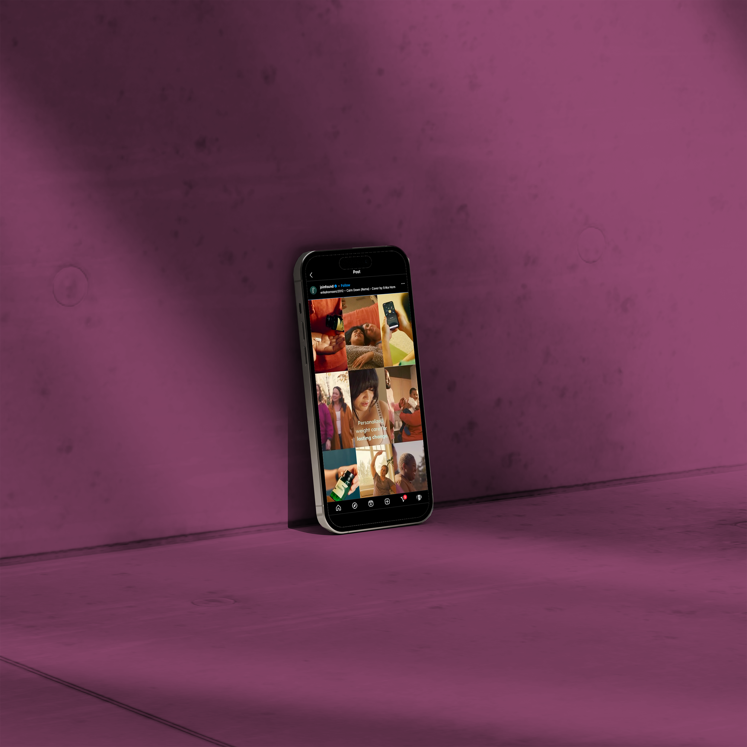 A smartphone leaning against a purple wall, displaying a social media grid of various photos of people, including a woman with red hair and a woman with dark hair, in different settings.