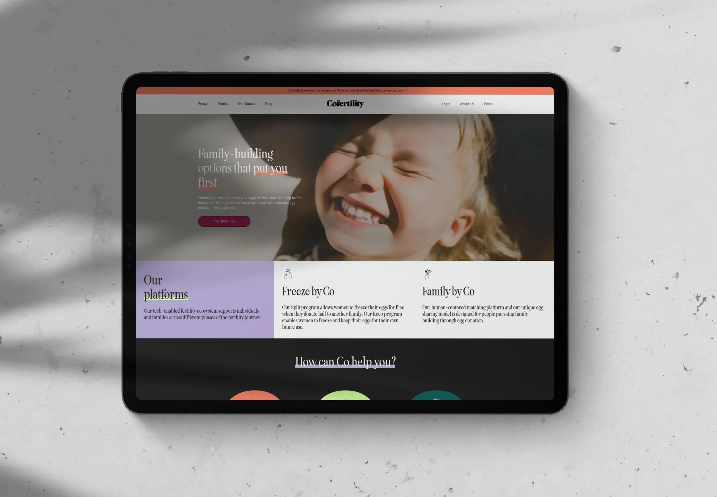 Tablet on a white surface displaying a website about family-building options, featuring a smiling young girl and text about fertility and egg donation programs.