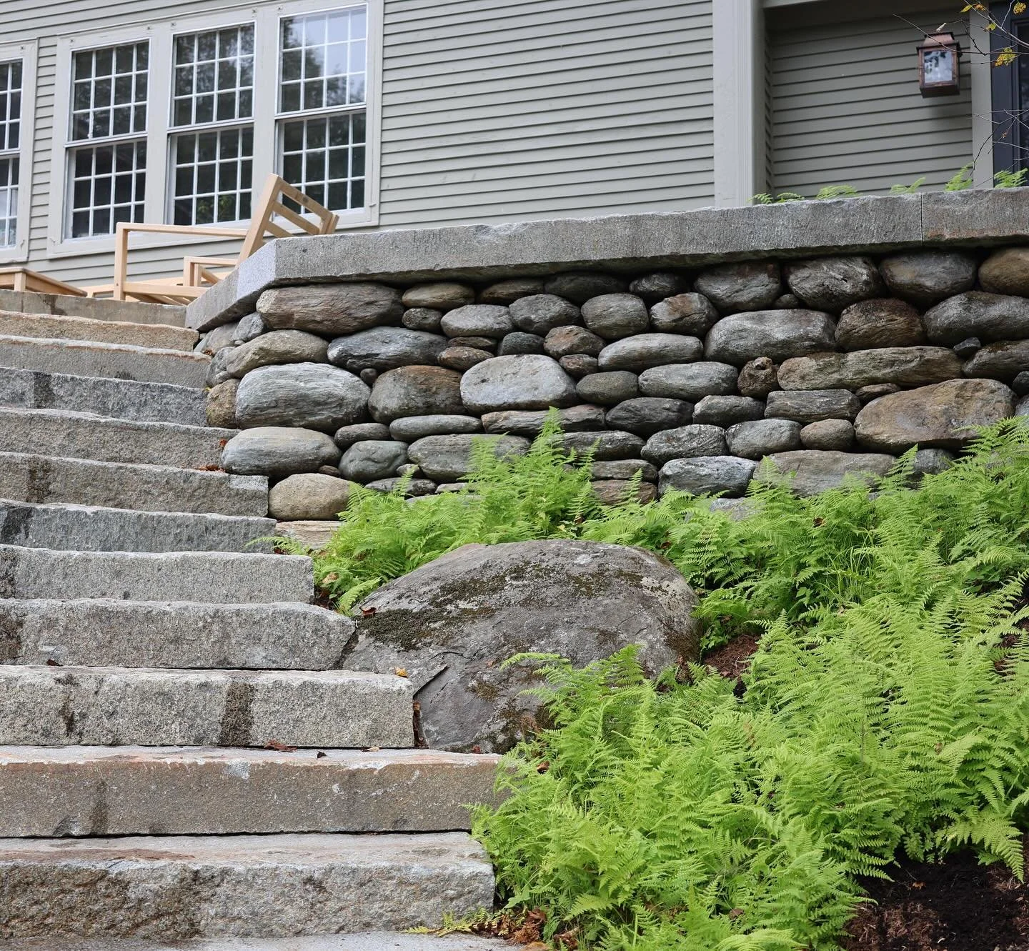 A stone master class from @featherandwedgemasonry, using a mix of reclaimed granite and fieldstone harvested from the property. 

Big thanks to @be_tee for his fern sod assistance today.