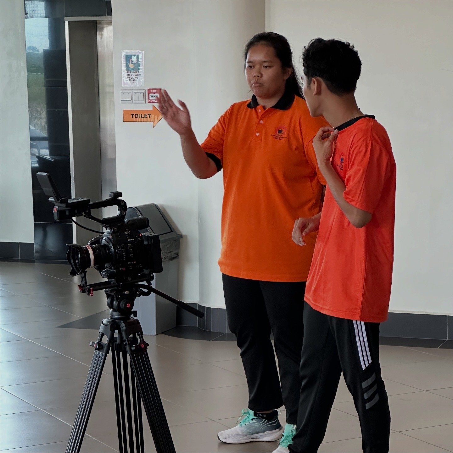 CENTEXS students receiving hands-on training in corporate interview camera setup during on-location video production in Kuching