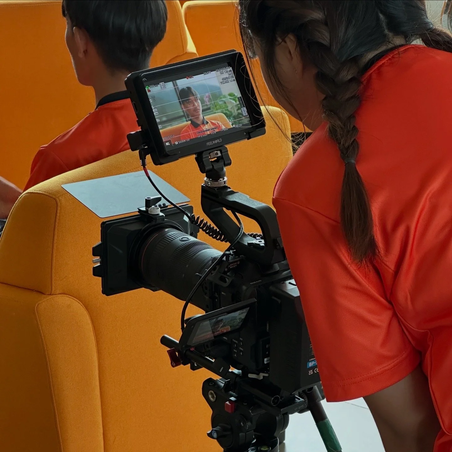 Behind-the-scenes view of CENTEXS students learning corporate interview filming techniques using professional production cameras