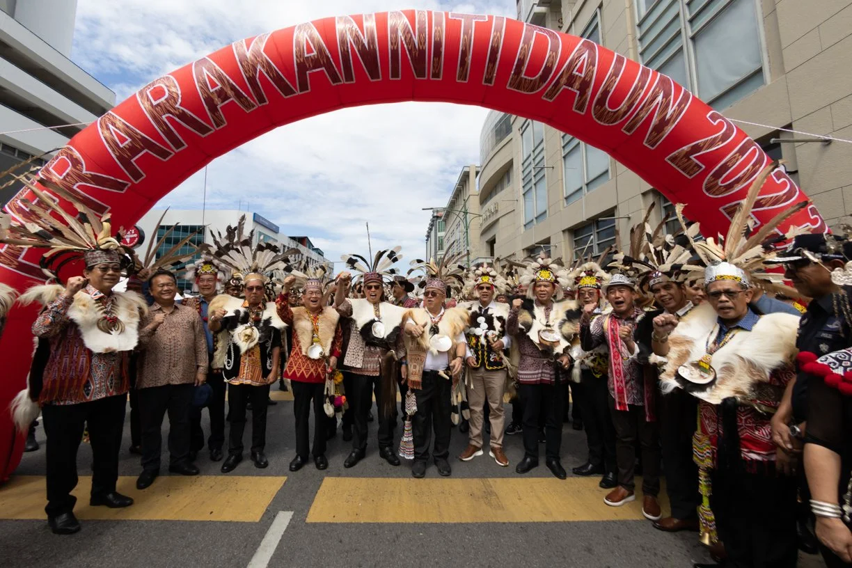 Gawai Dayak cultural parade at Kuching Waterfront area featuring traditional attire and ceremonial opening, photographed as part of professional event coverage.