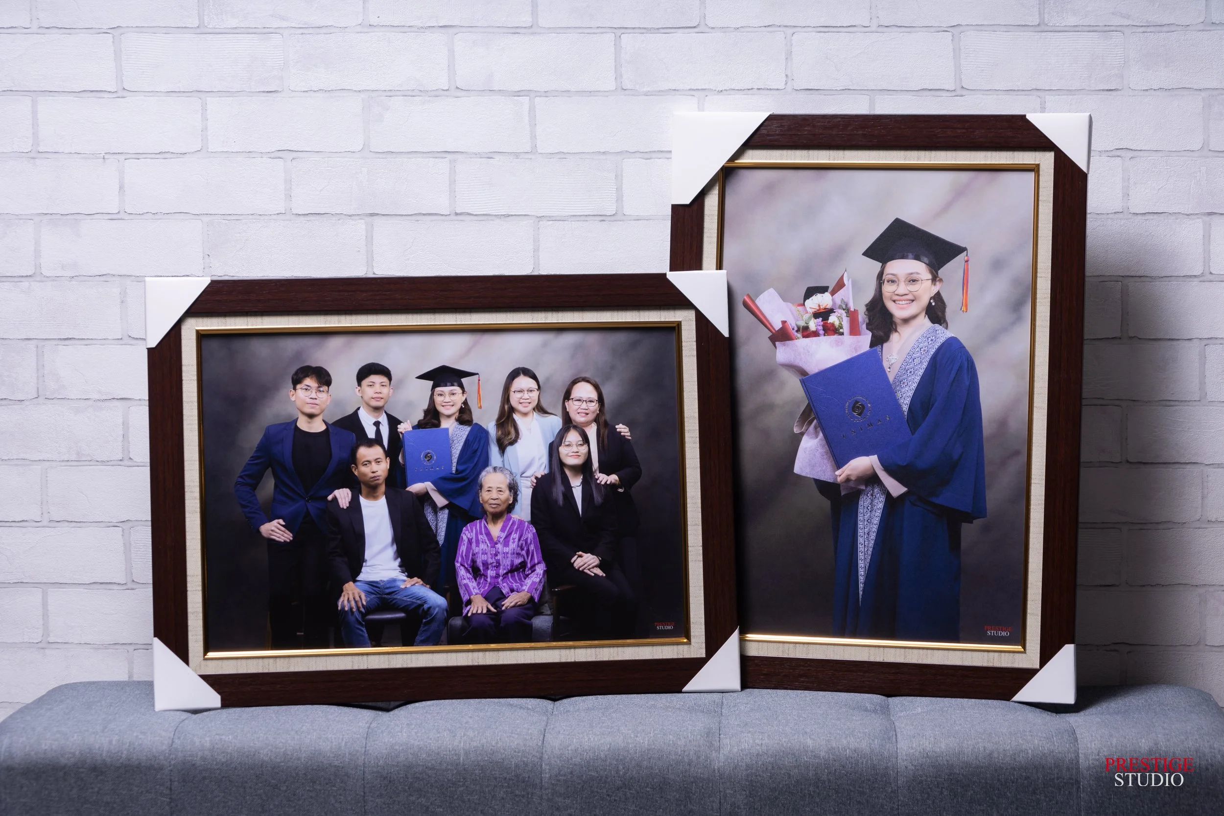 Graduation family portrait session in Kuching featuring a graduate with family members and framed wall portraits.