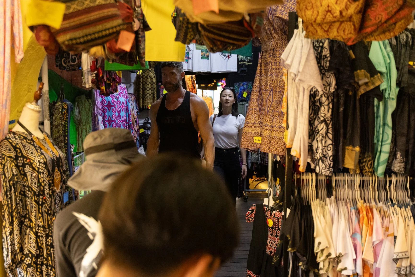 Behind the scenes of a Sarawak Tourism Board commercial shoot with talents walking through a local market while crew films the scene
