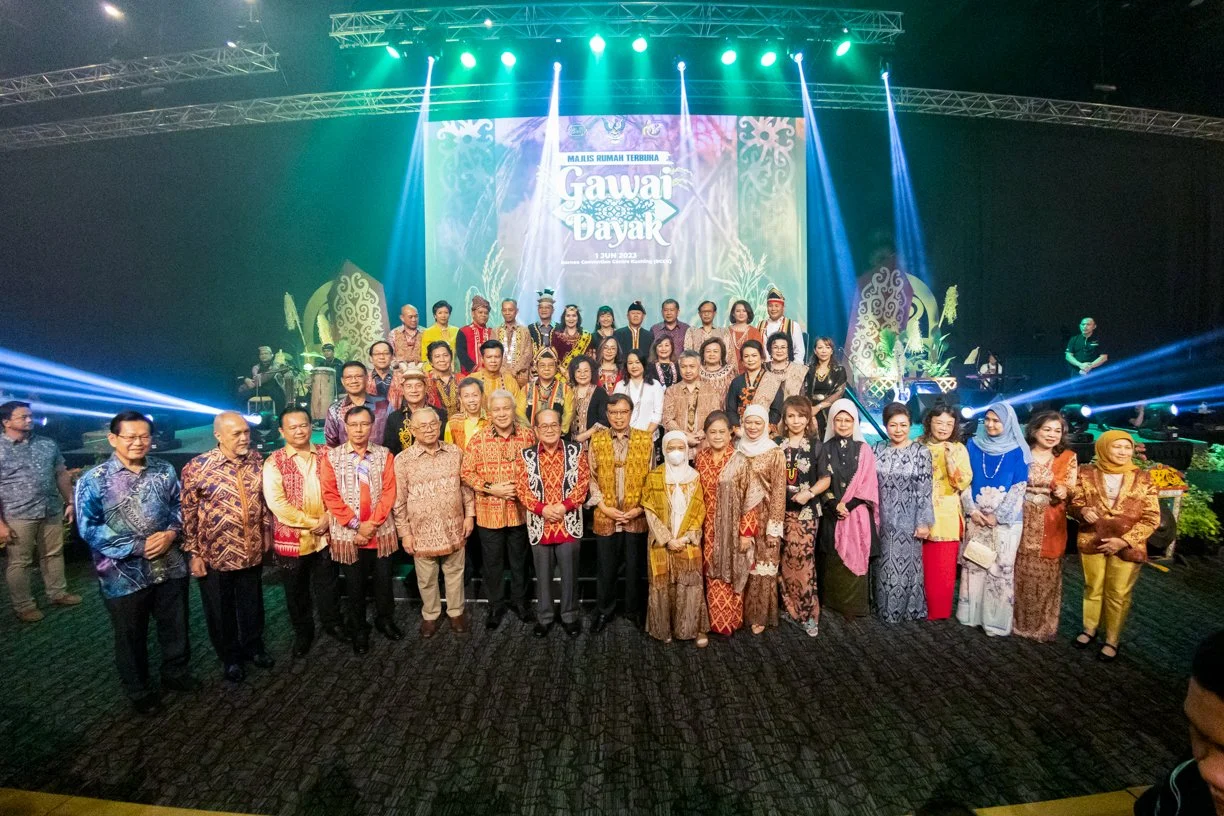 Group photo of guests and officials at a Gawai Dayak celebration in Kuching, BCCK, captured on stage during an official cultural event.