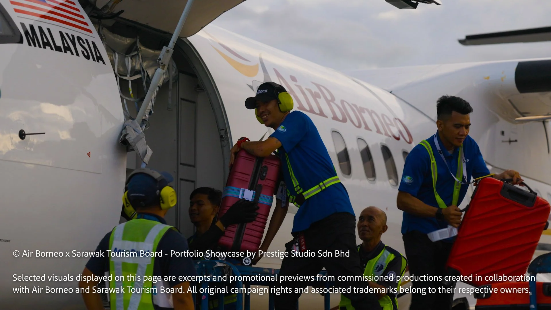 Ground crew loading luggage into an Air Borneo aircraft during airport operations