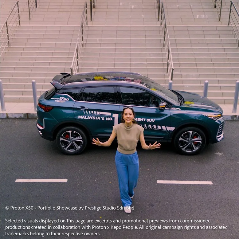 Top angle shot of Proton X50 with presenter standing beside the SUV