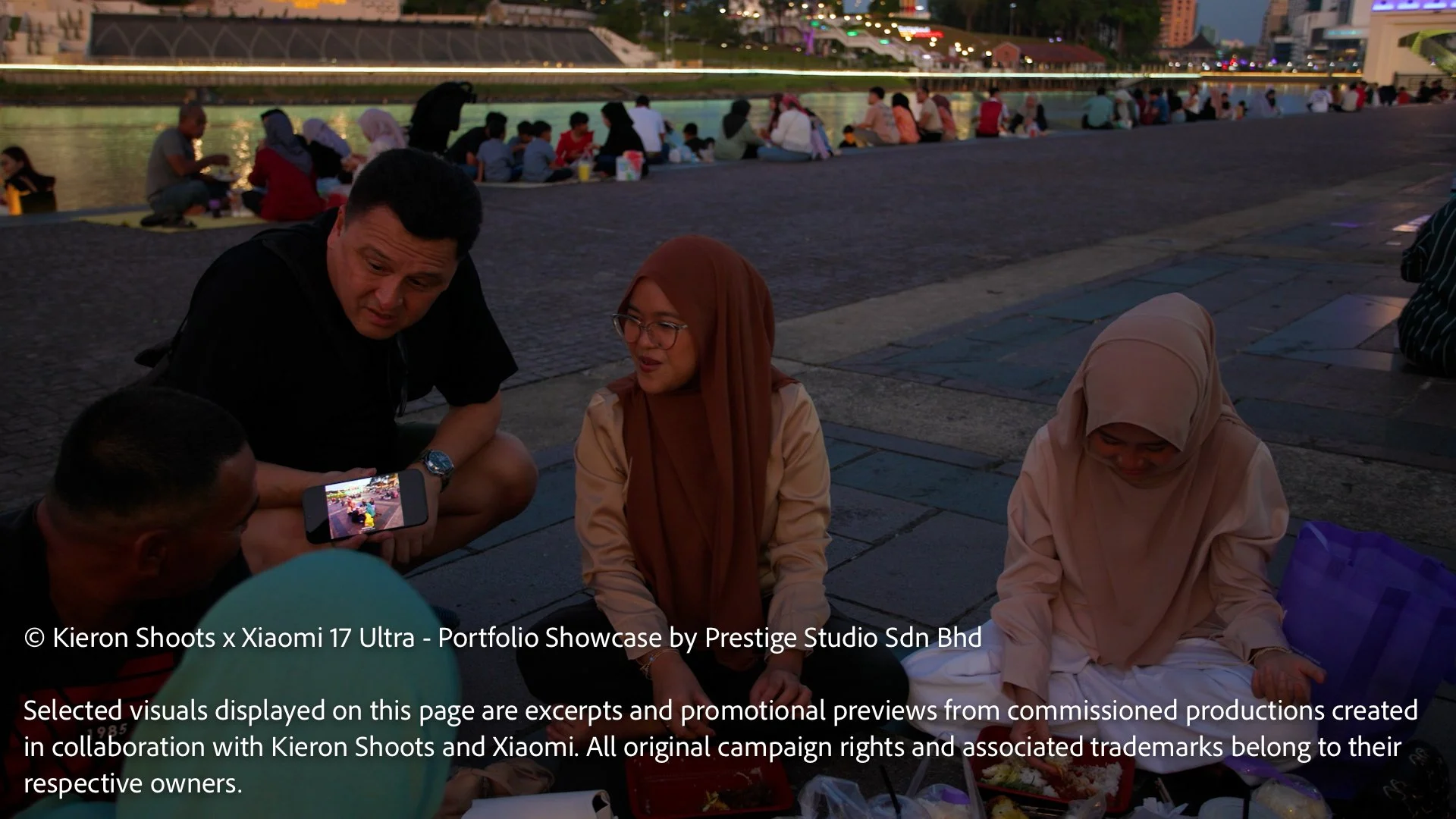 Kieron Long interacting with locals at Kuching Waterfront during the Xiaomi 17 Ultra street photography series in Sarawak.