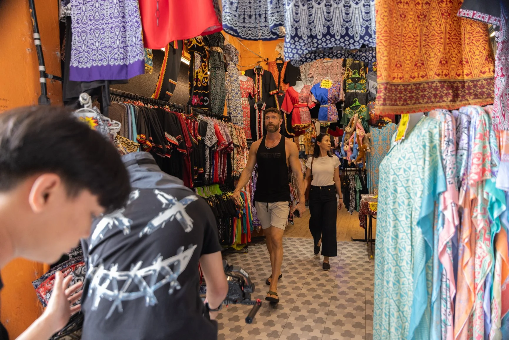 Behind the scenes of a Sarawak Tourism Board commercial shoot with crew filming talents walking through a local market