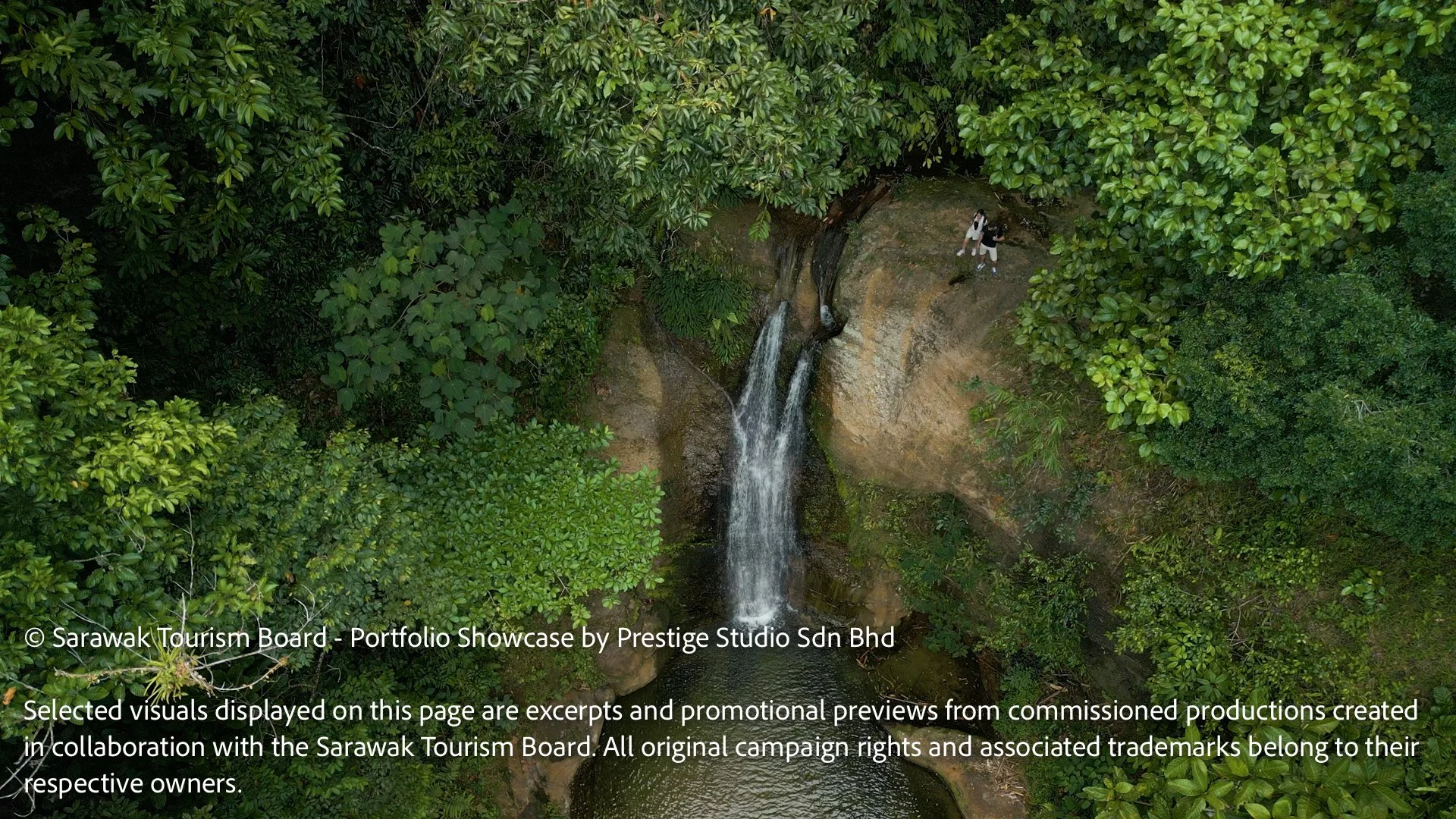 Cinematic drone view of Ban Buan Kukuot Waterfall in Sarawak, Borneo filmed for the Gateway to Borneo tourism commercial campaign by Prestige Studio Sdn Bhd.