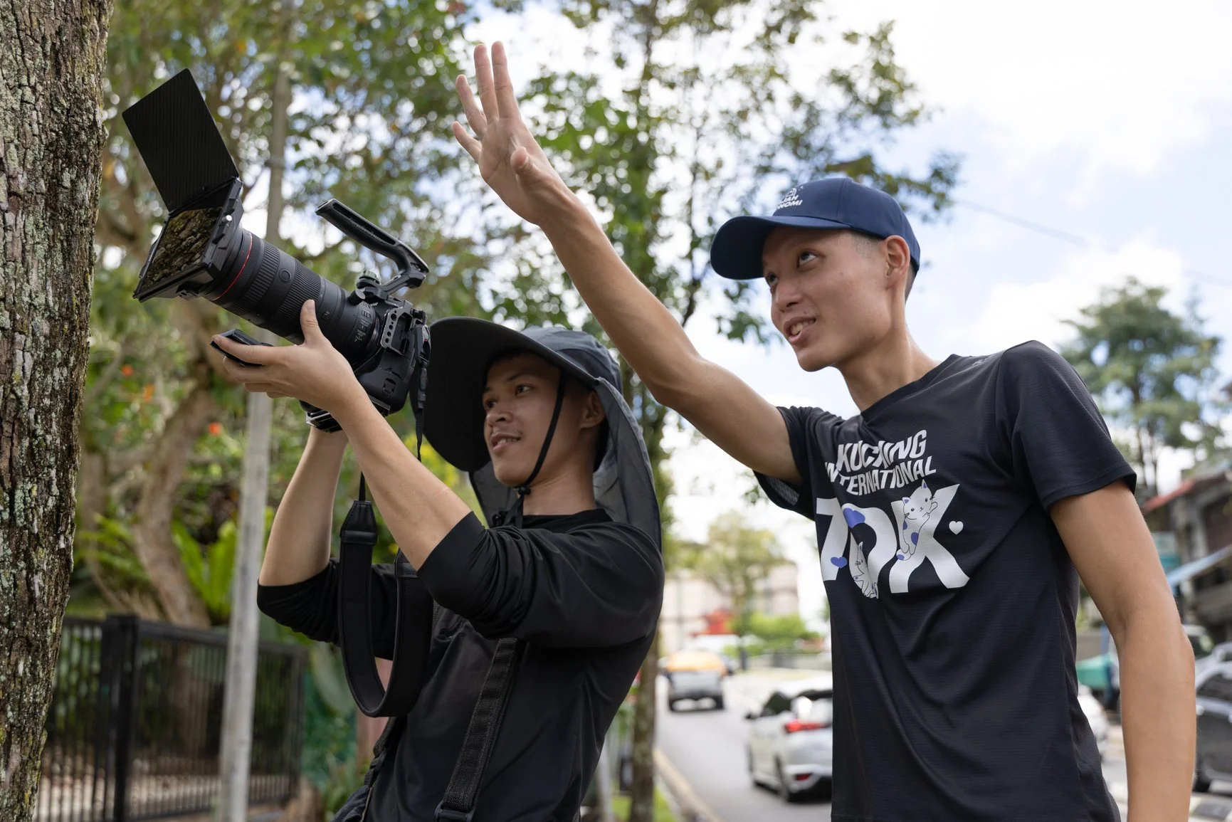 Behind the scenes of a Sarawak Tourism Board commercial shoot with crew filming a street mural in Kuching