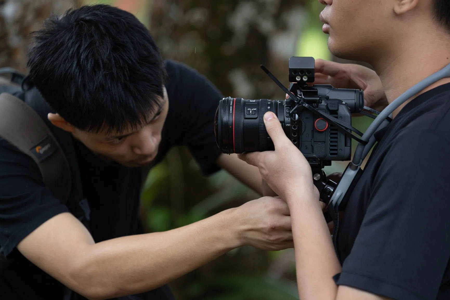 Close-up behind the scenes of film crew setting up a camera rig during a Sarawak Tourism commercial shoot