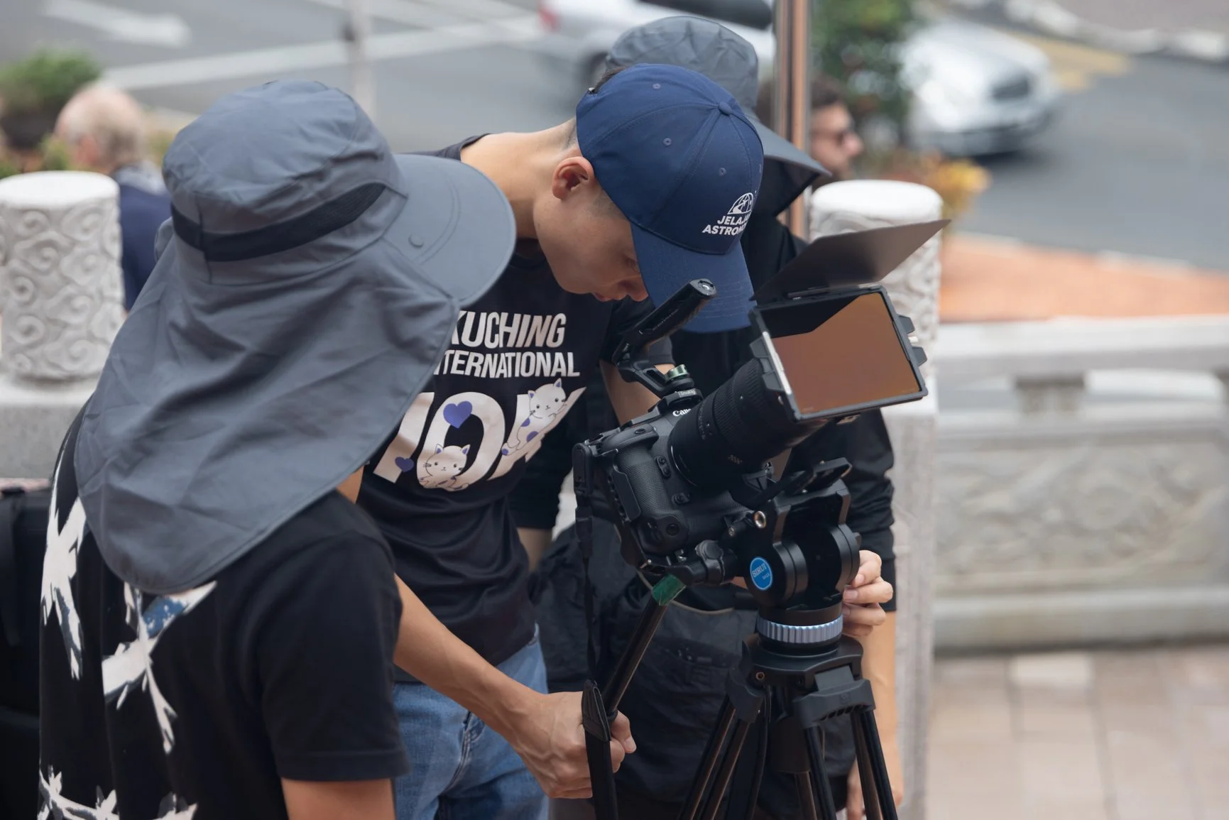 Behind the scenes of the film crew reviewing footage during a Sarawak Tourism Board commercial shoot