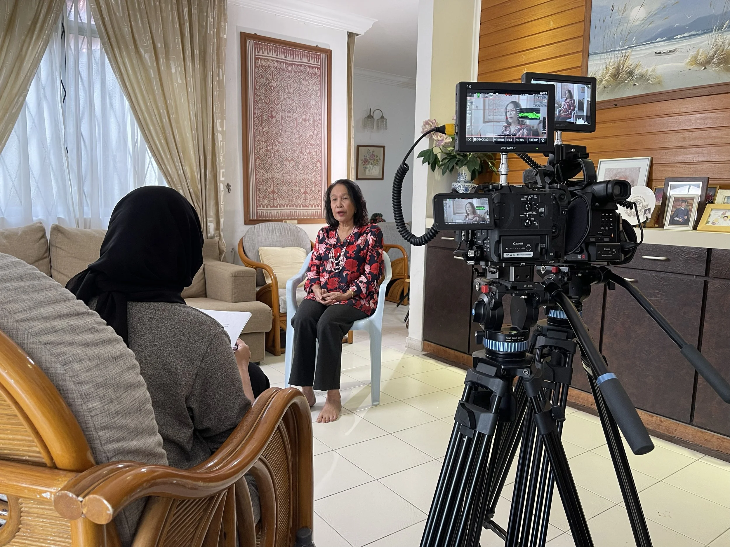 Behind-the-scenes filming of a documentary interview for the television series “Sarawak Women in History,” captured in a residential setting.
